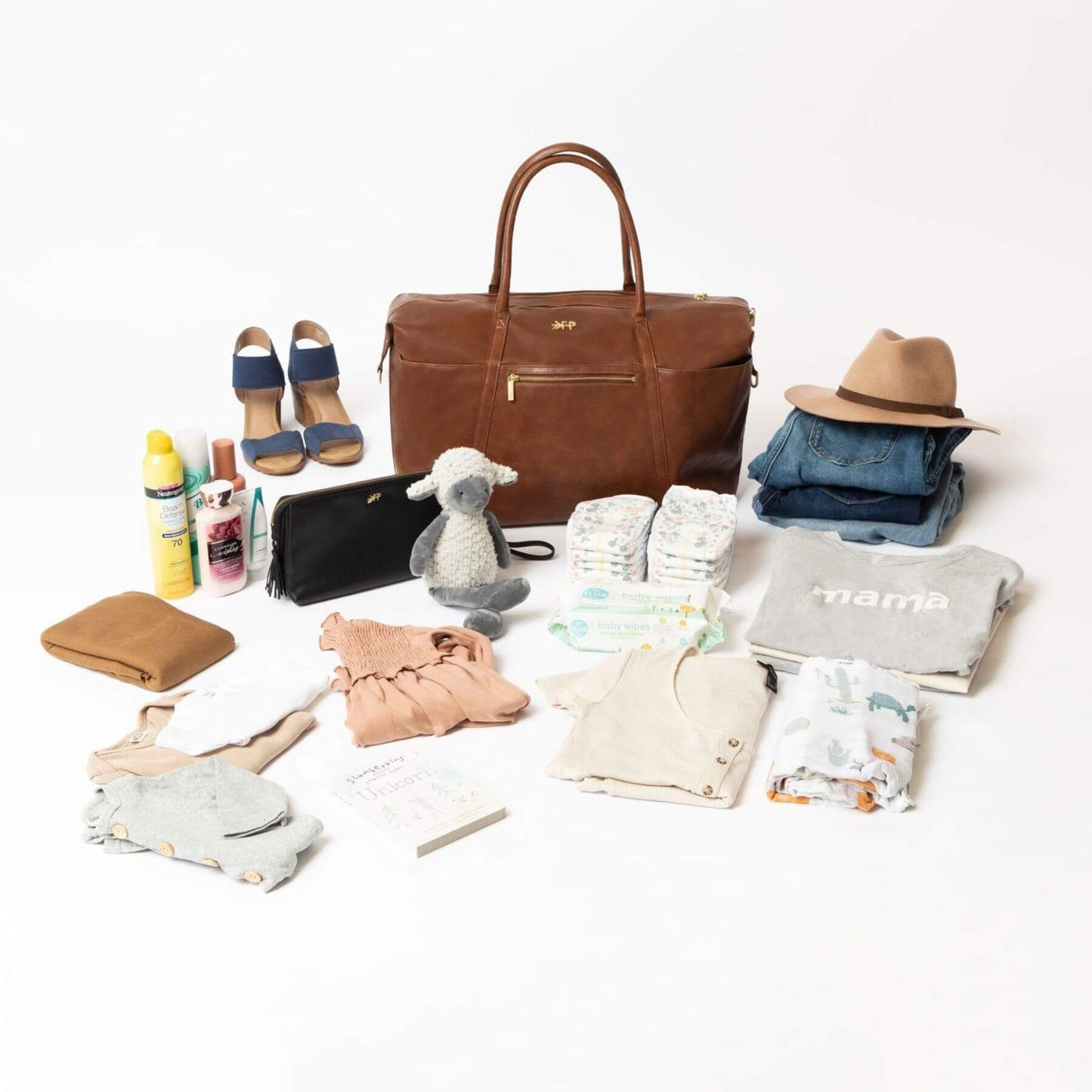 Collection of baby items including a brown bag, diapers, clothes, and accessories on a white background.