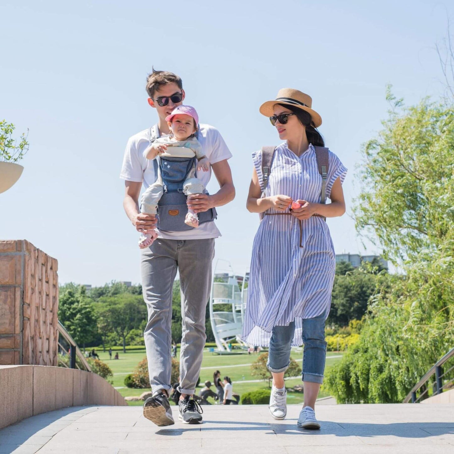 Parents carrying a baby with Sunveno Ergonomic Baby Carrier 3-in-1