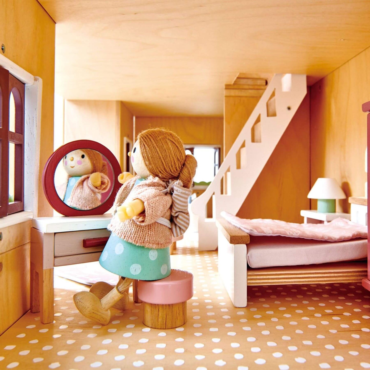 Toy bear in a dollhouse with a mirror and furniture