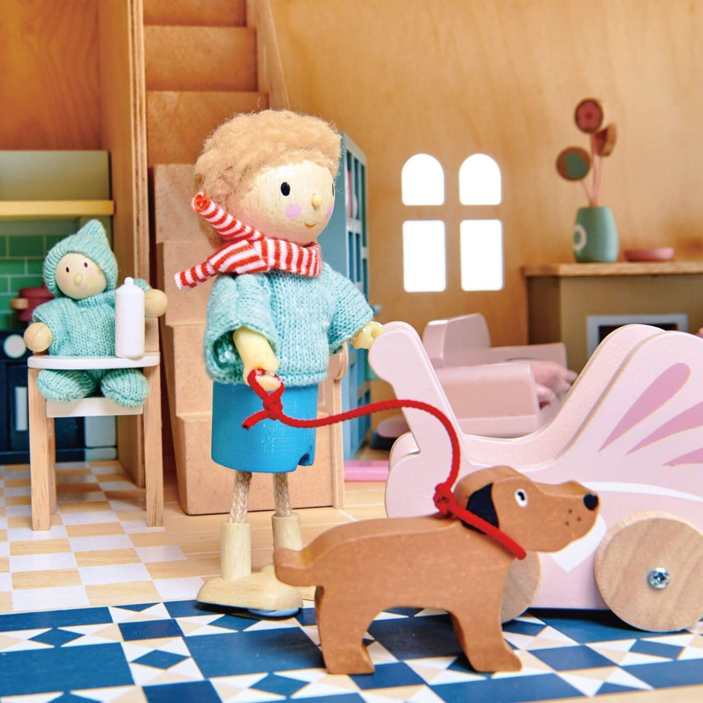 Wooden toy figure of a child with a dog in a dollhouse setting
