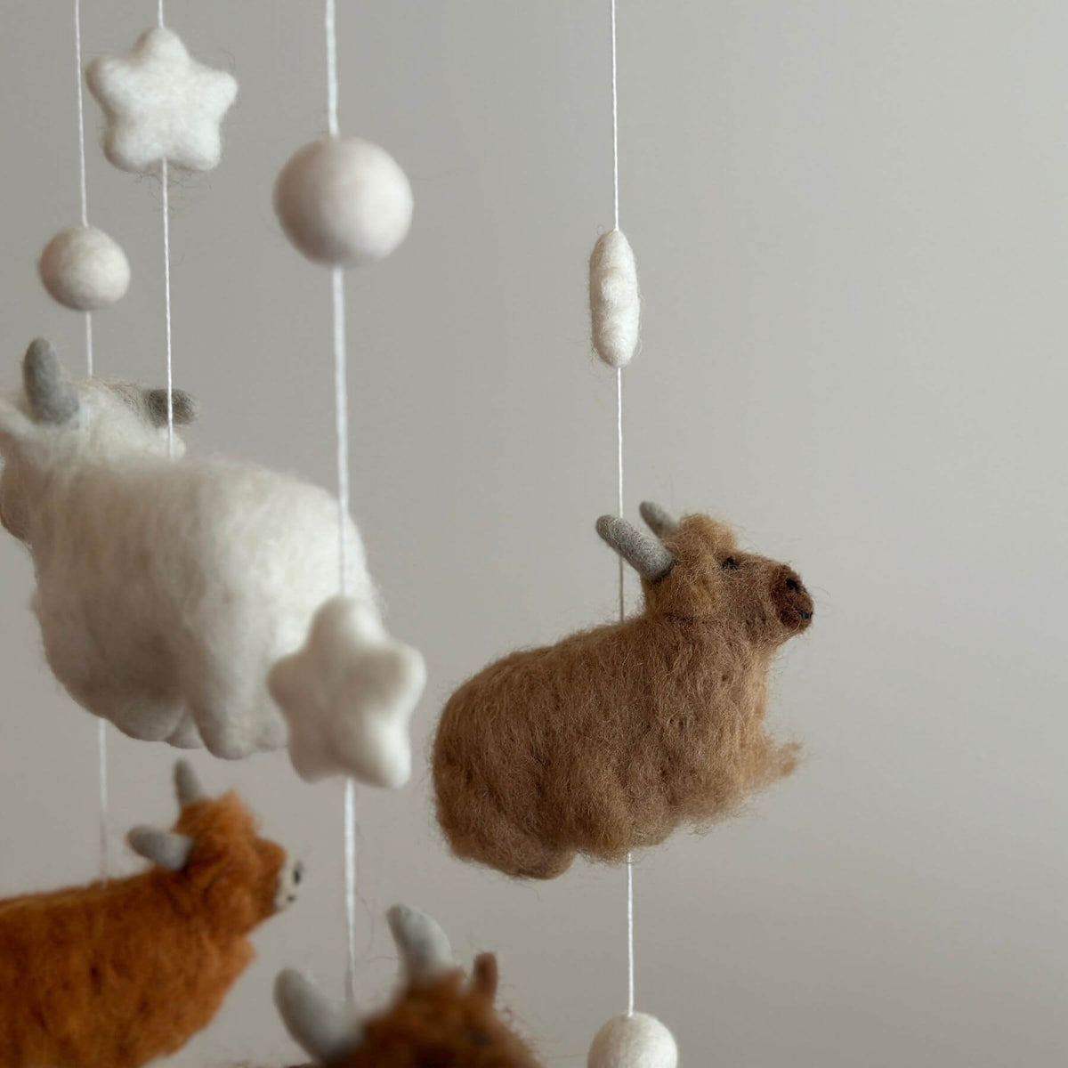 Close-up of Ganapati Crafts Co. Felt Baby Mobile - Highland Cow