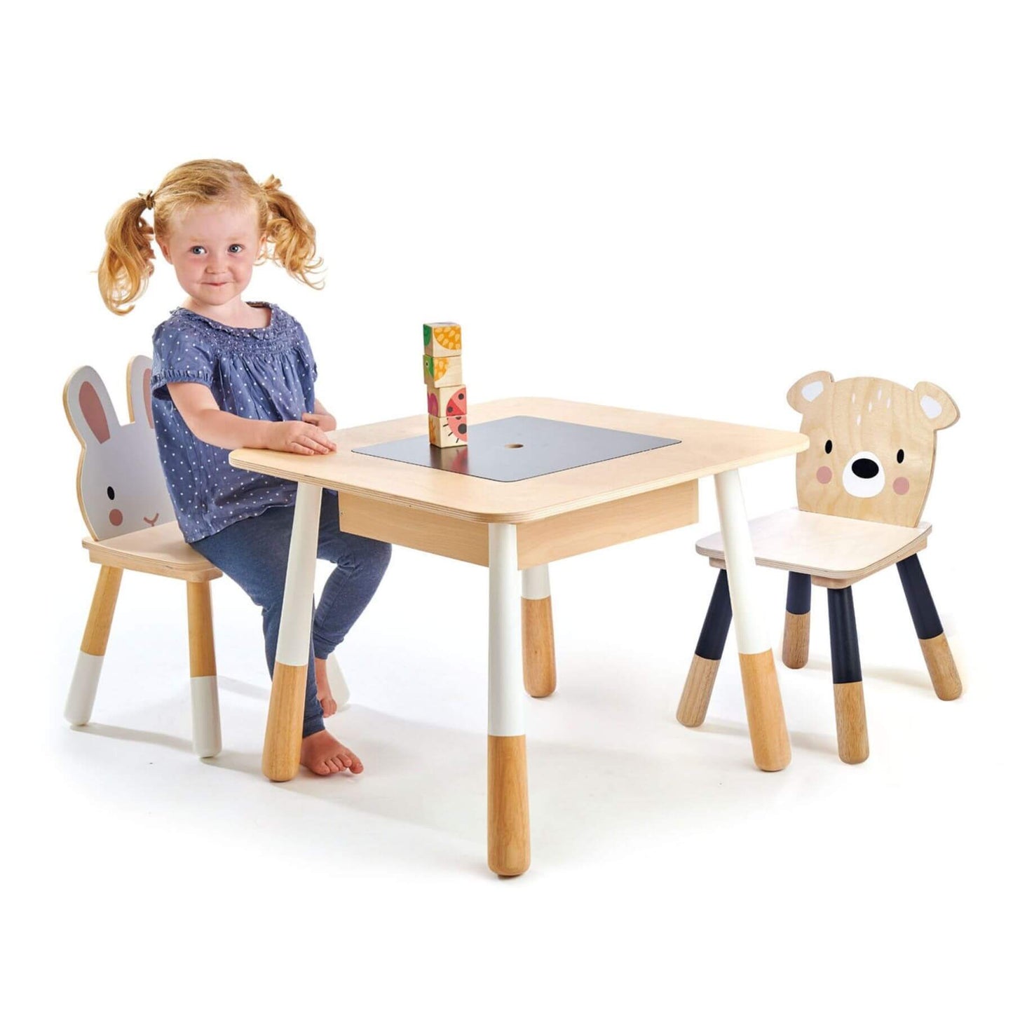 Child sitting at Tender Leaf Forest Table and Chairs on a white background