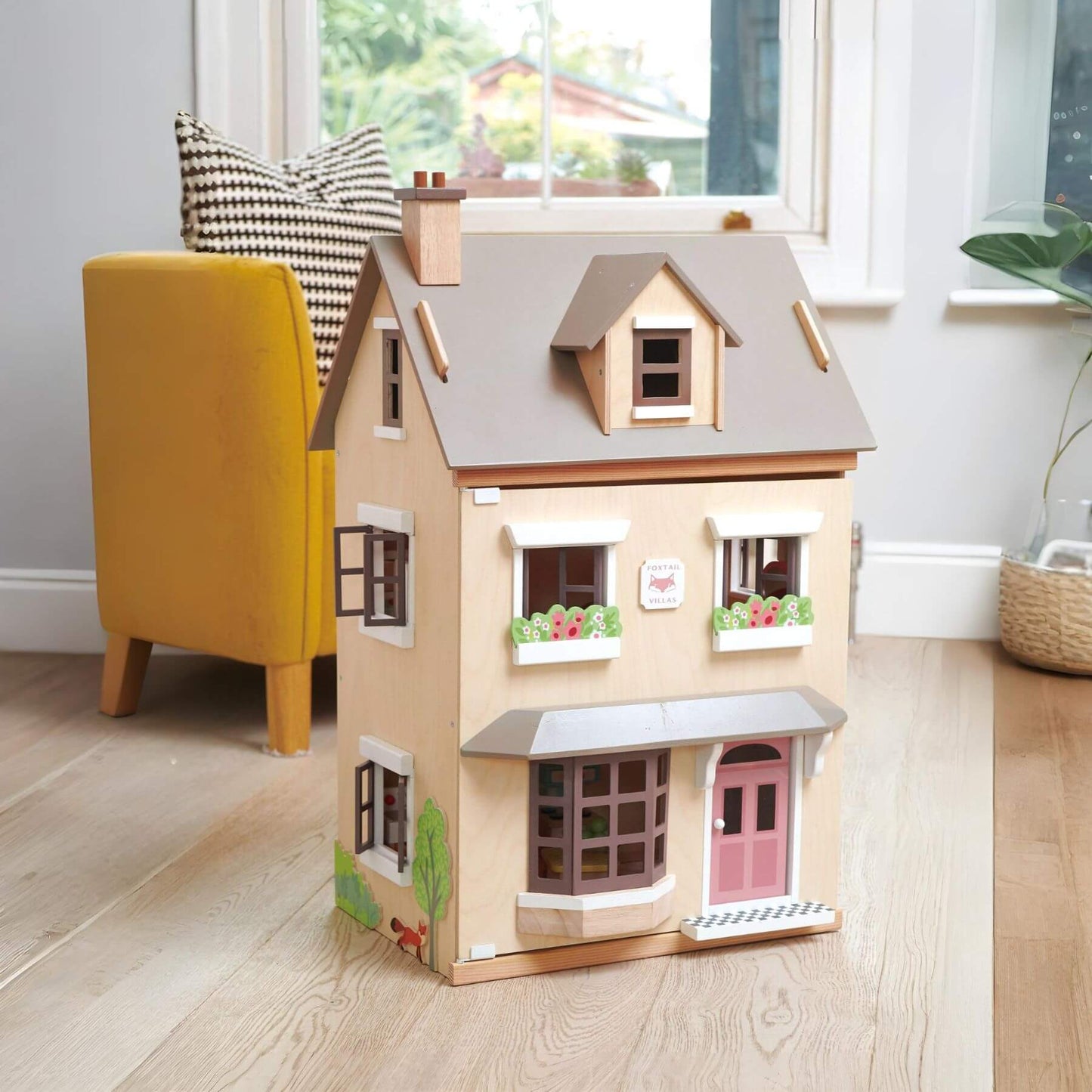 Tender Leaf Foxtail Villa on a wooden floor, yellow chair with plaid cushion in the background