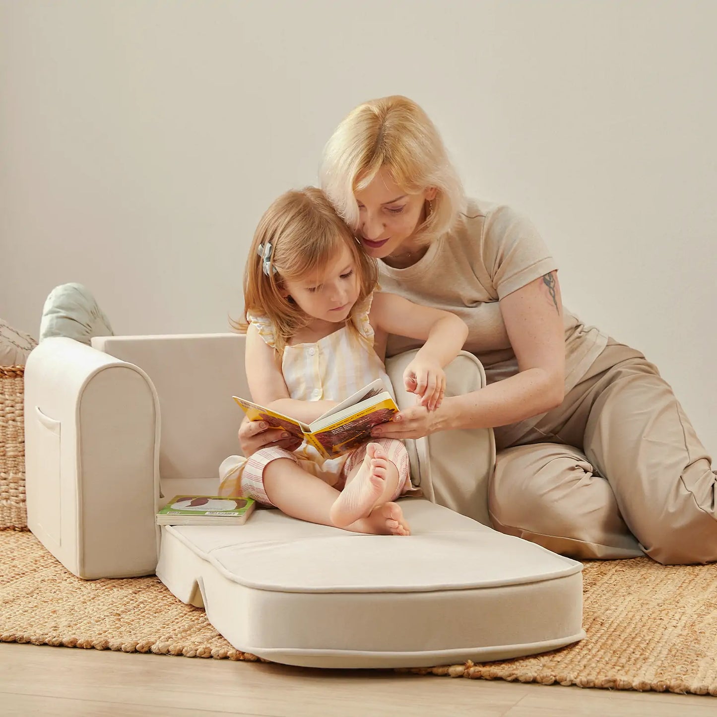 Woman and child reading a book onTiny Land® GentleSnug Kid Chair Beige White with a neutral background