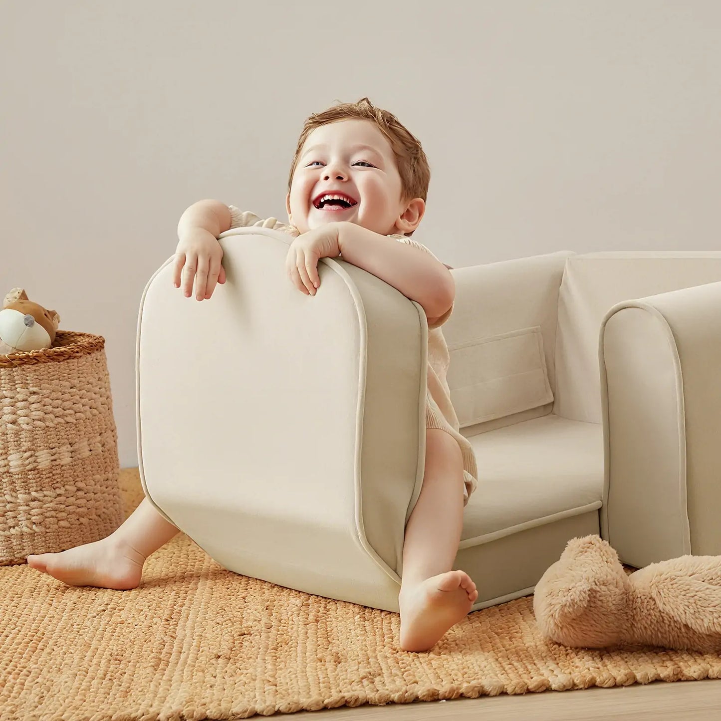 Child playing with Tiny Land® GentleSnug Kid Chair Beige White in a cozy living room