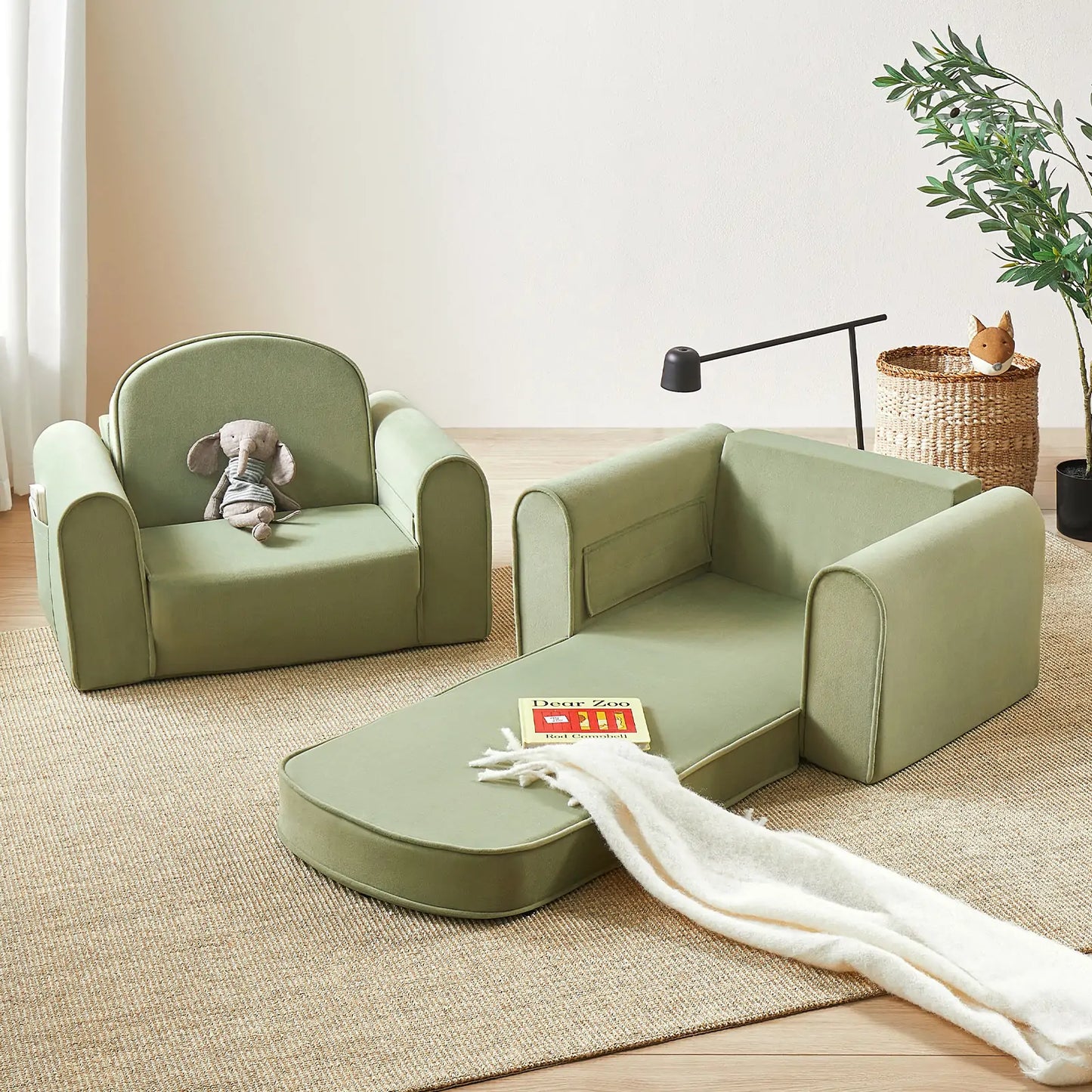Tiny Land® GentleSnug Kid Chair Sage with a toy and blanket on a wooden floor.