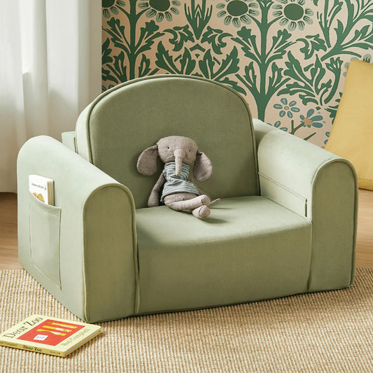 Tiny Land® GentleSnug Kid Chair Sage with a plush elephant toy and a book on a carpeted floor.