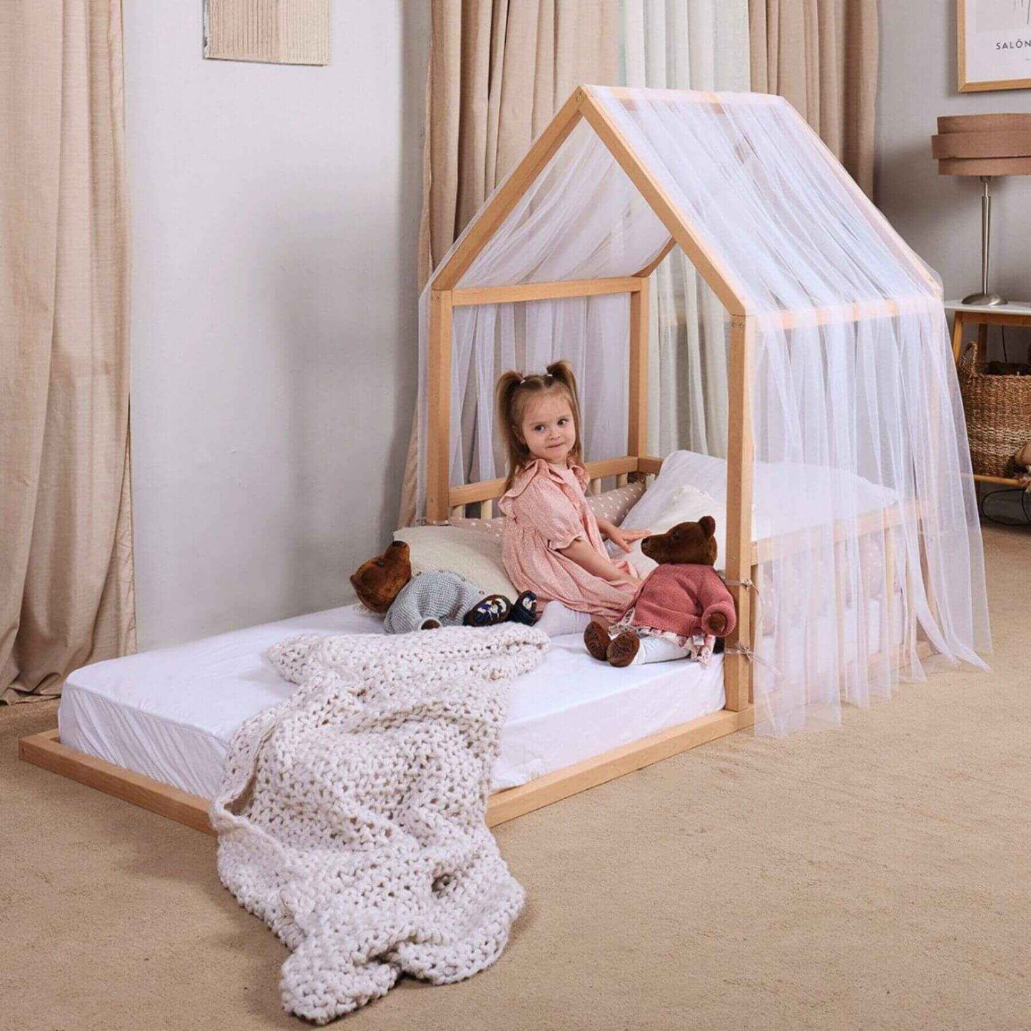 Kid Sitting on Goodevas Wooden Montessori House Floor Bed, in bedroom