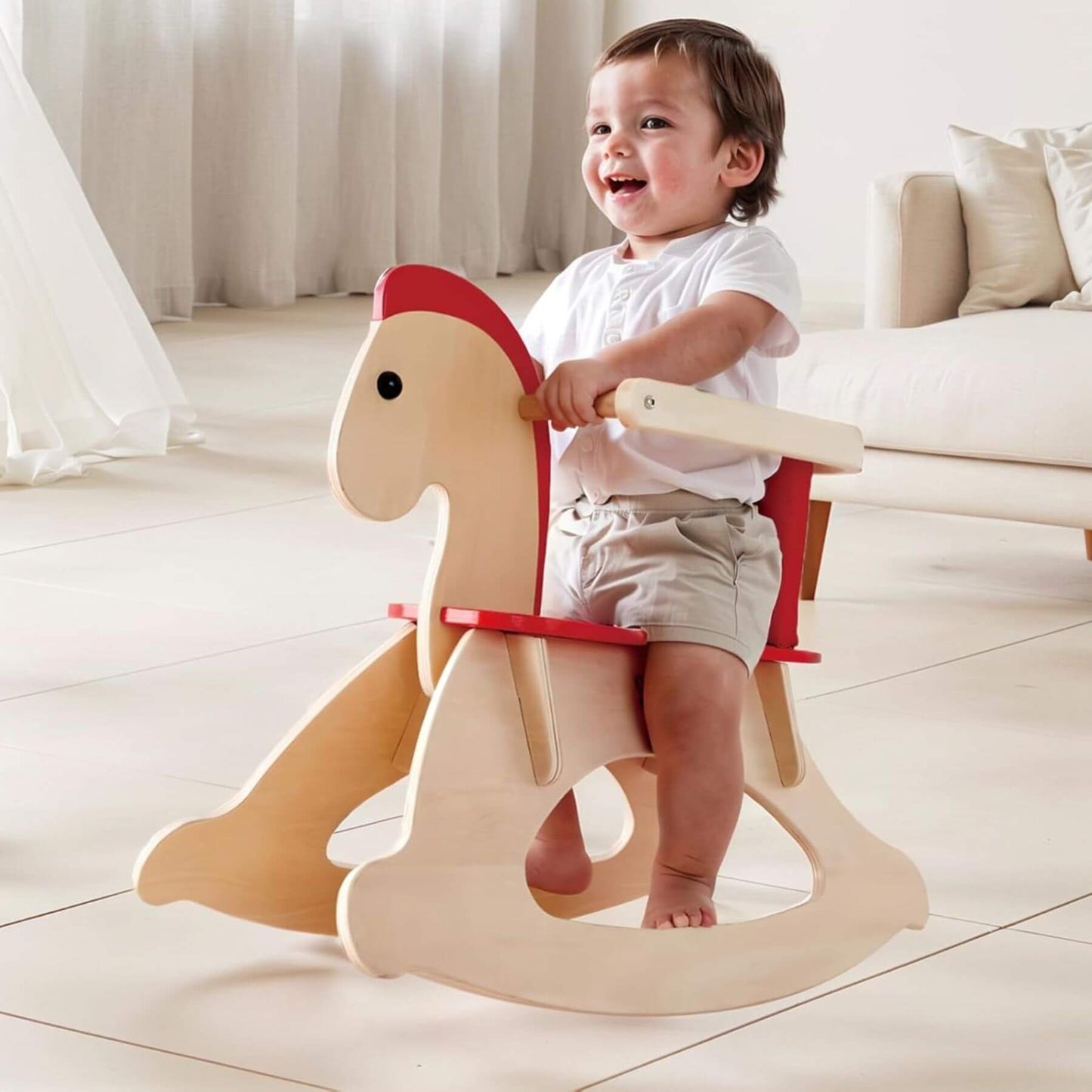 Child playing with Hape Grow-with-me Rocking Horse in a bright room.
