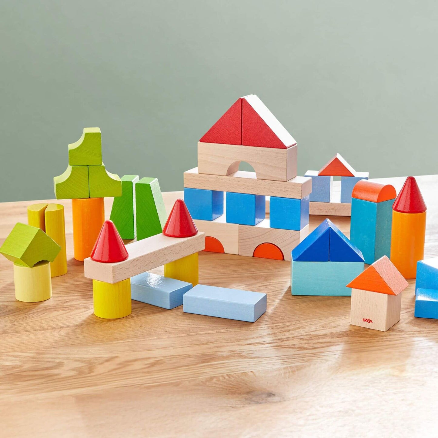 HABA USA Colored Wooden Building Blocks - 46 Piece Set on a wooden surface with a gray background