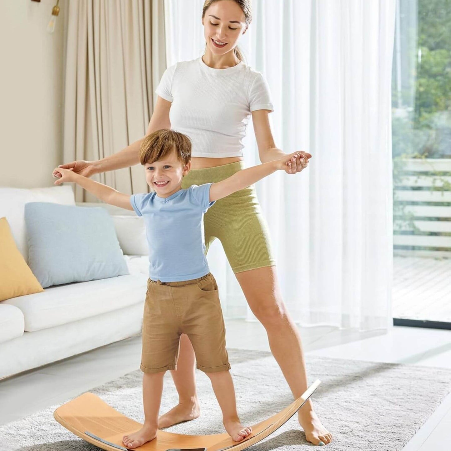 Woman and child using Hape Light Up Balance Board in a living room.