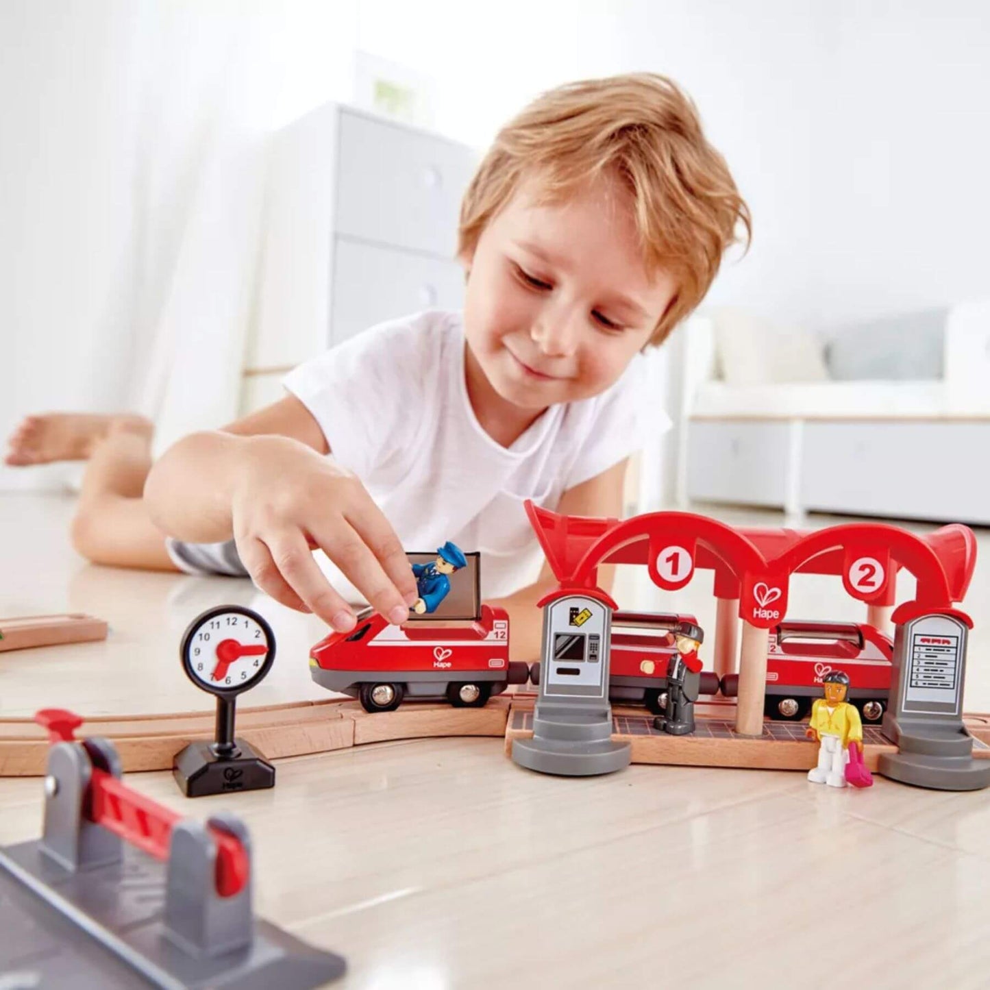 Boy Playing Hape Busy City Rail Set