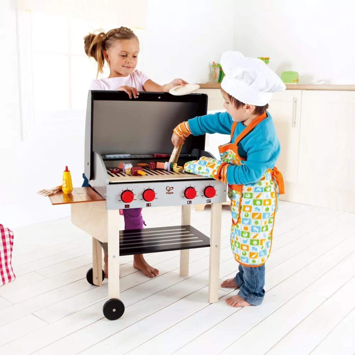 Two Kids Playing Hape Gourmet Grill (with food)