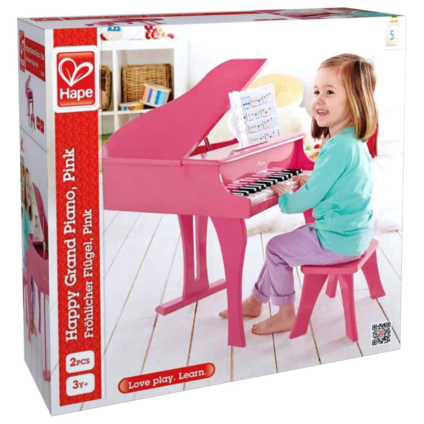 Box of Hape Happy Grand Piano Pink toy with a child playing on packaging