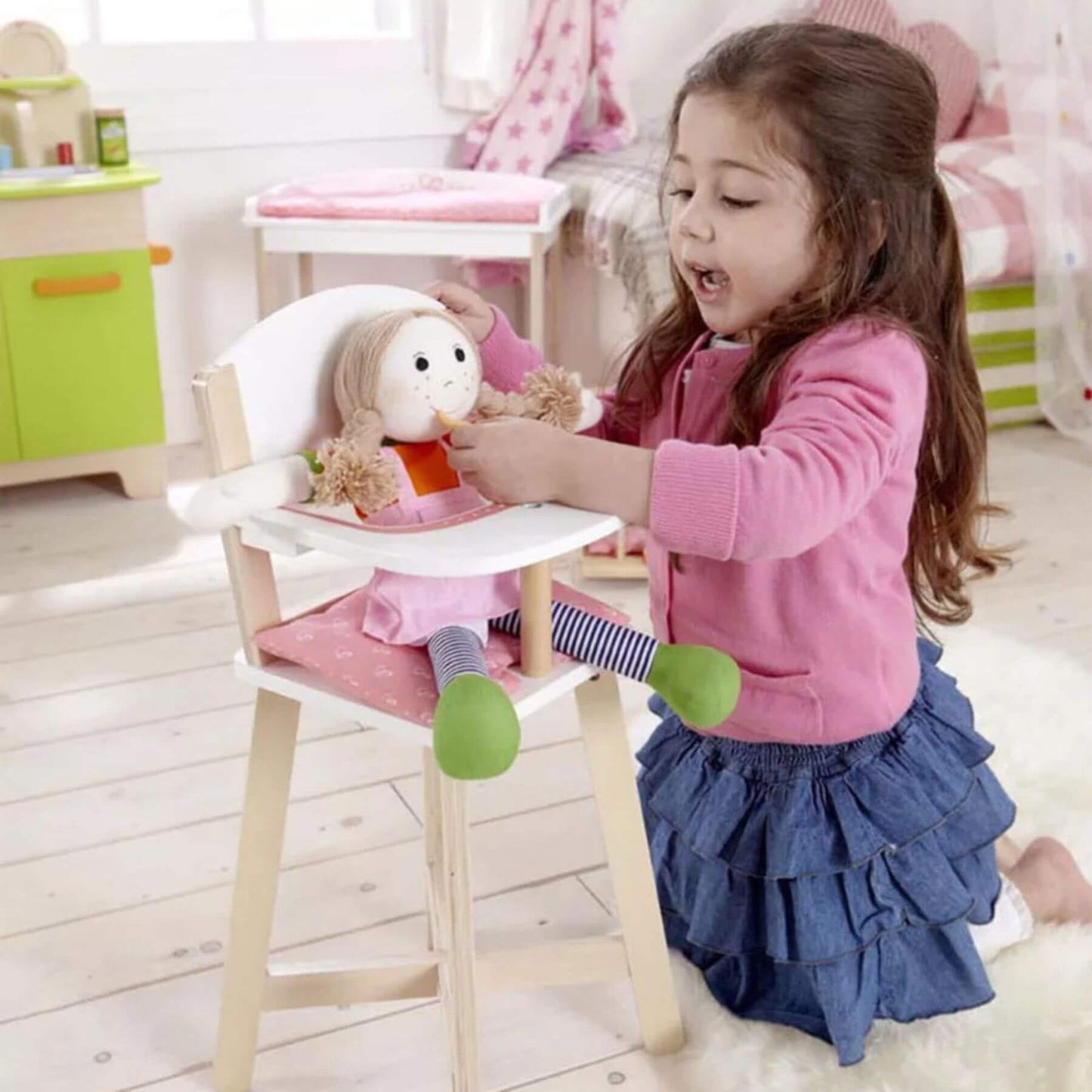 Girl Playing Doll on Hape Highchair