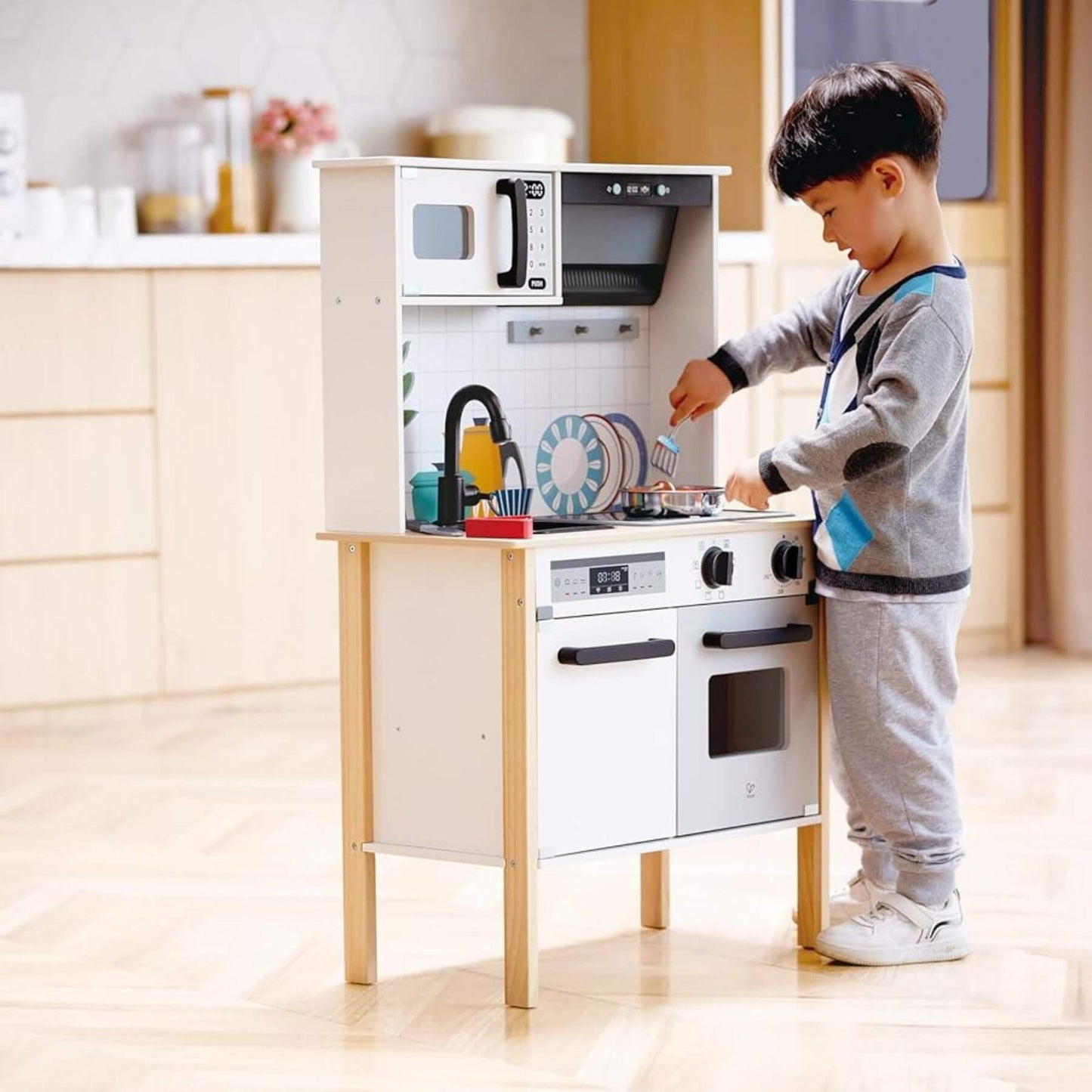 Boy Pretend Cooking on Hape Modern Smart Kitchen