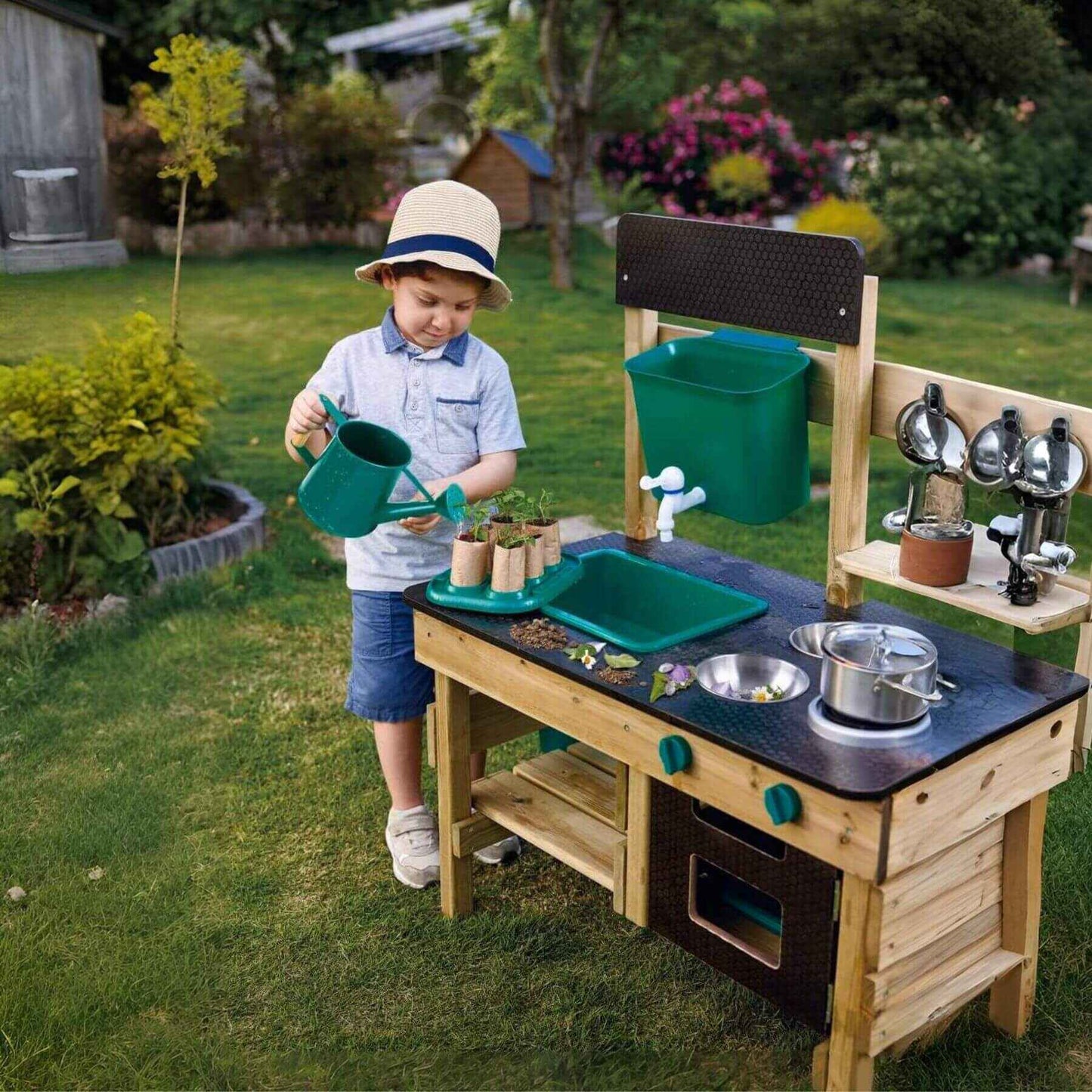 Boy Playing Hape Outdoor Kitchen
