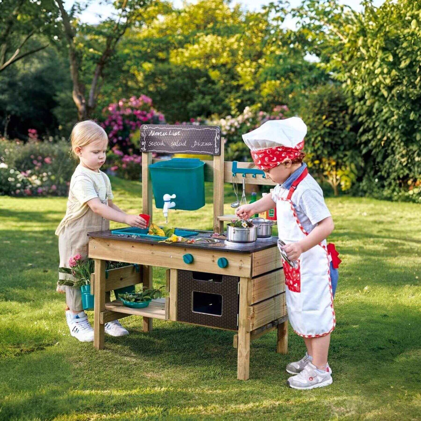 Two Kids Playing Hape Outdoor Kitchen