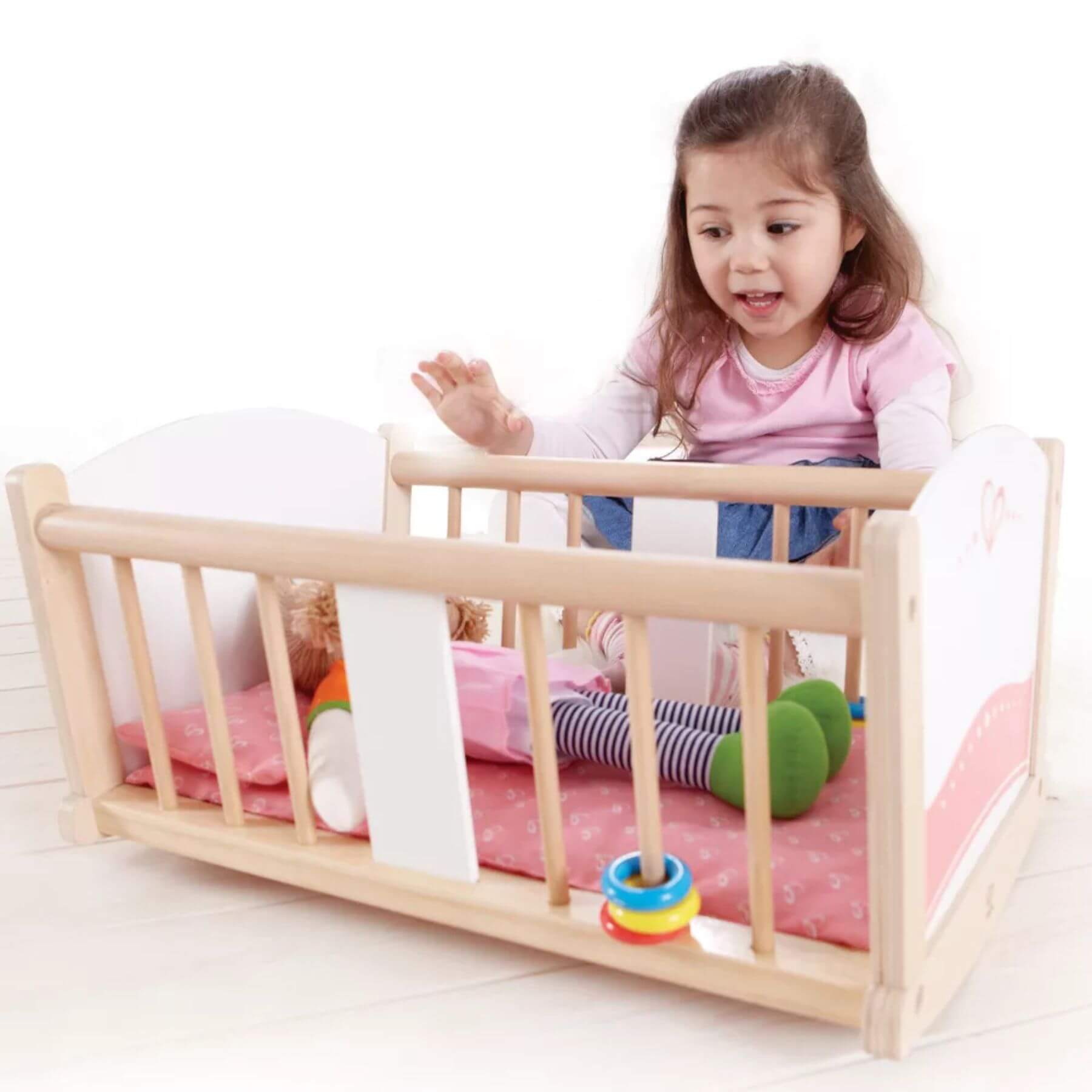Girl Playing Hape Rock-a-bye Cradle