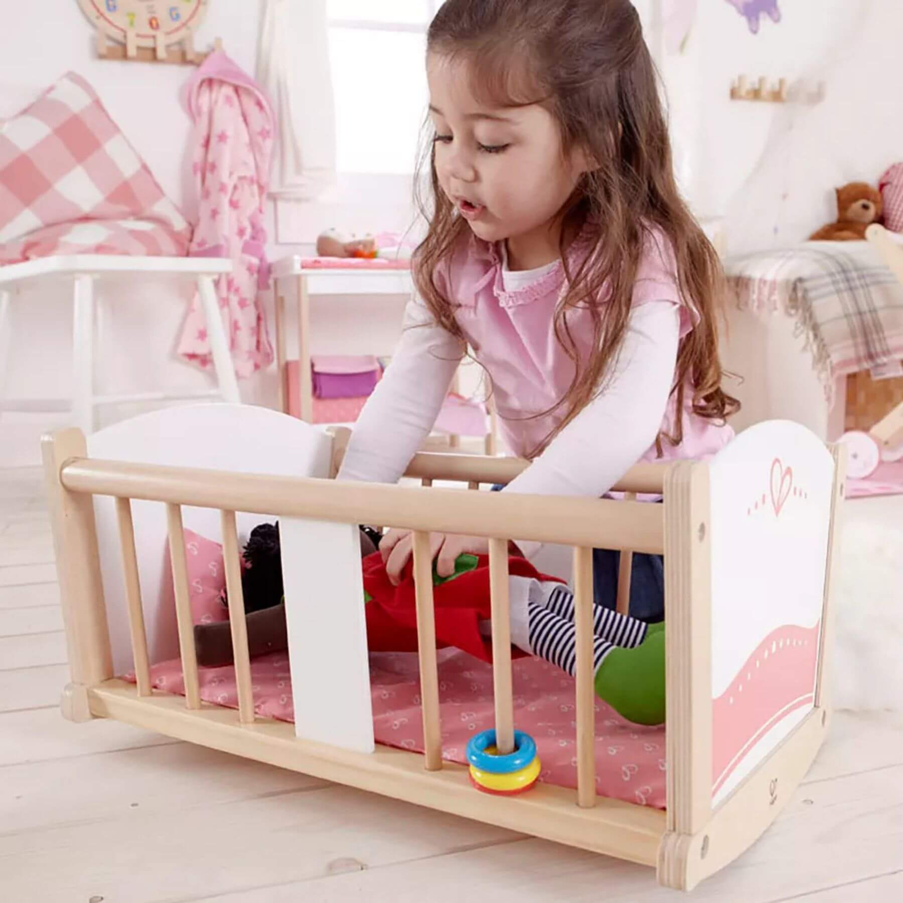 Girl Playing Hape Rock-a-bye Cradle