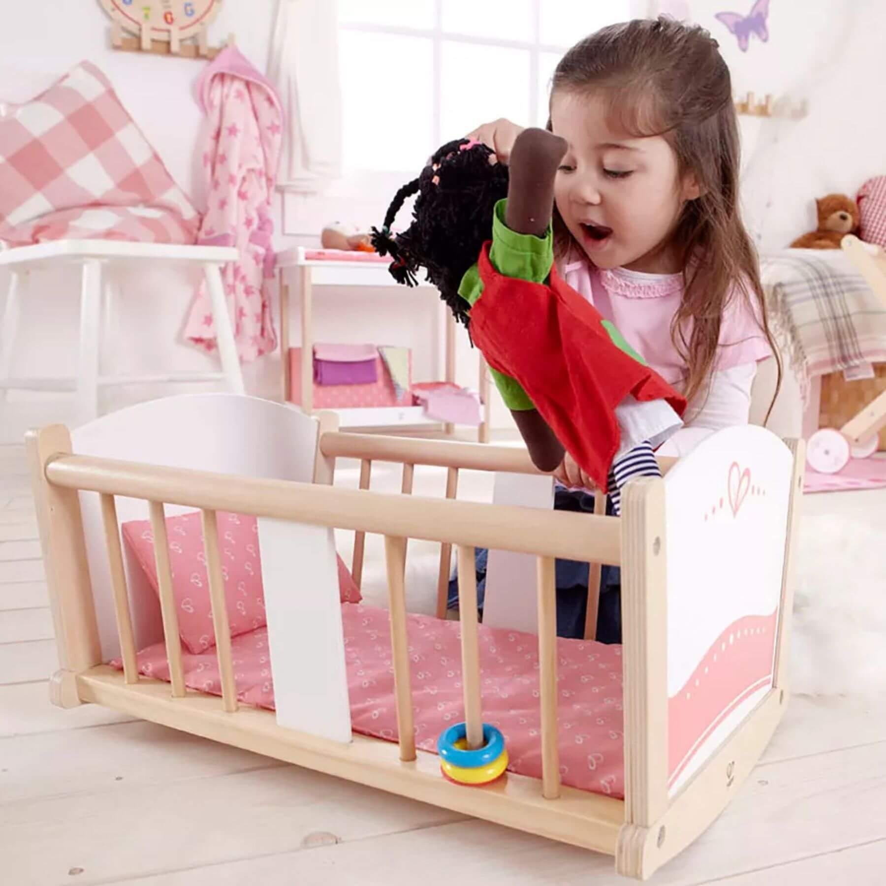 Girl Playing Hape Rock-a-bye Cradle