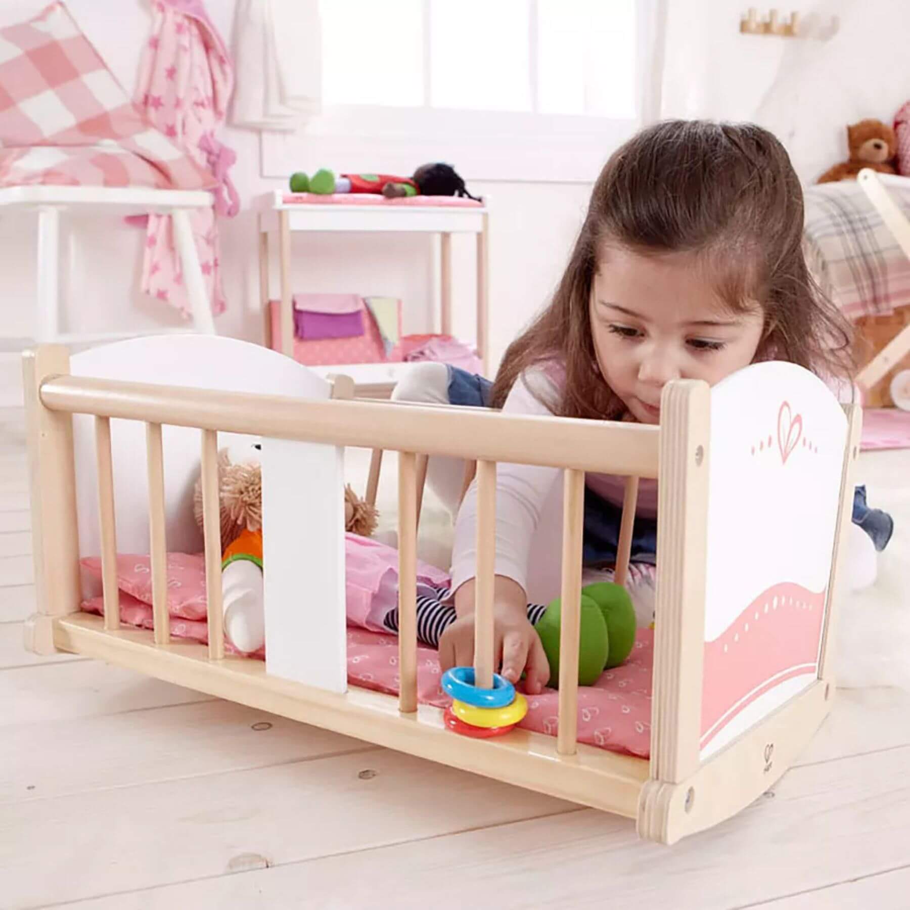 Girl Playing Hape Rock-a-bye Cradle