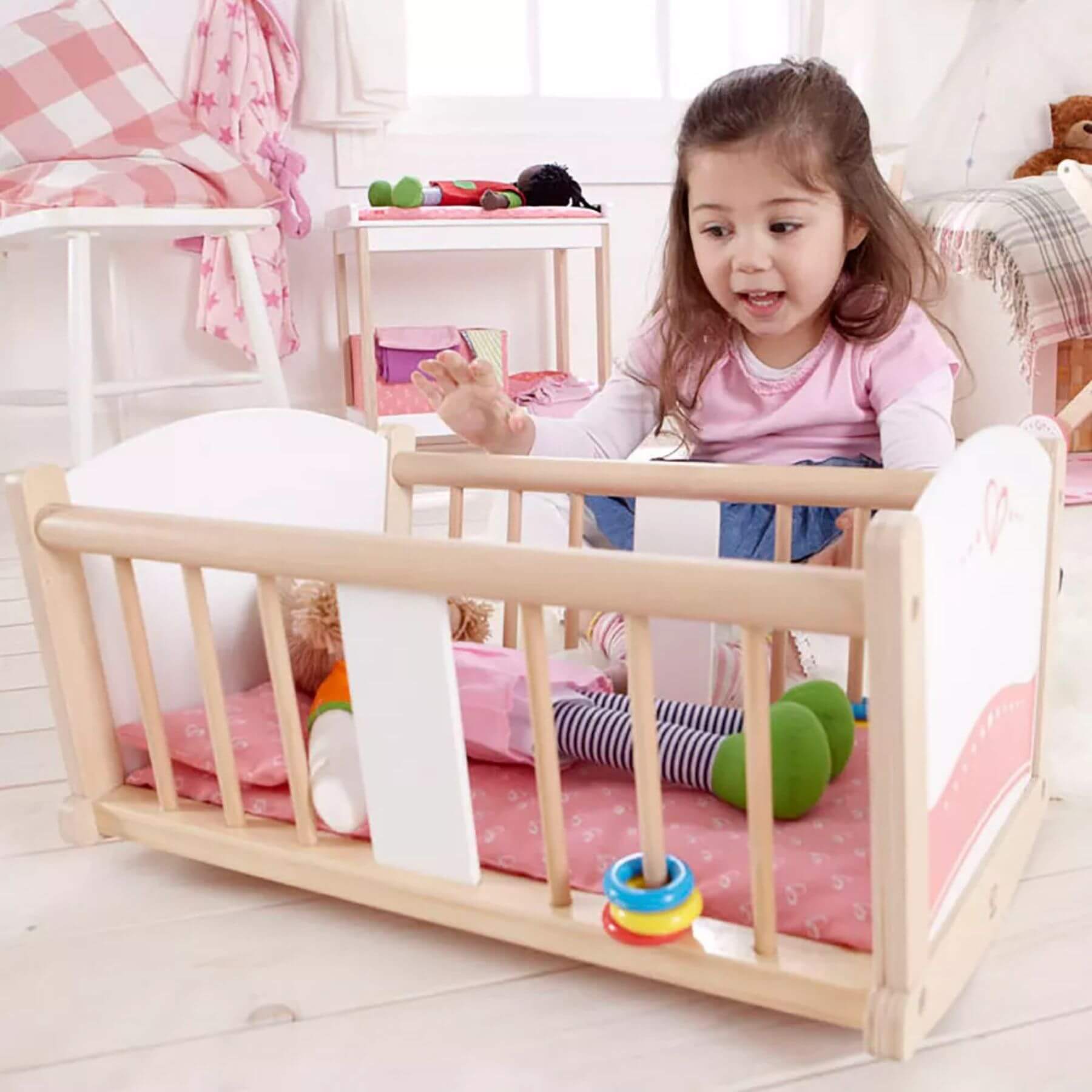 Girl Playing Hape Rock-a-bye Cradle