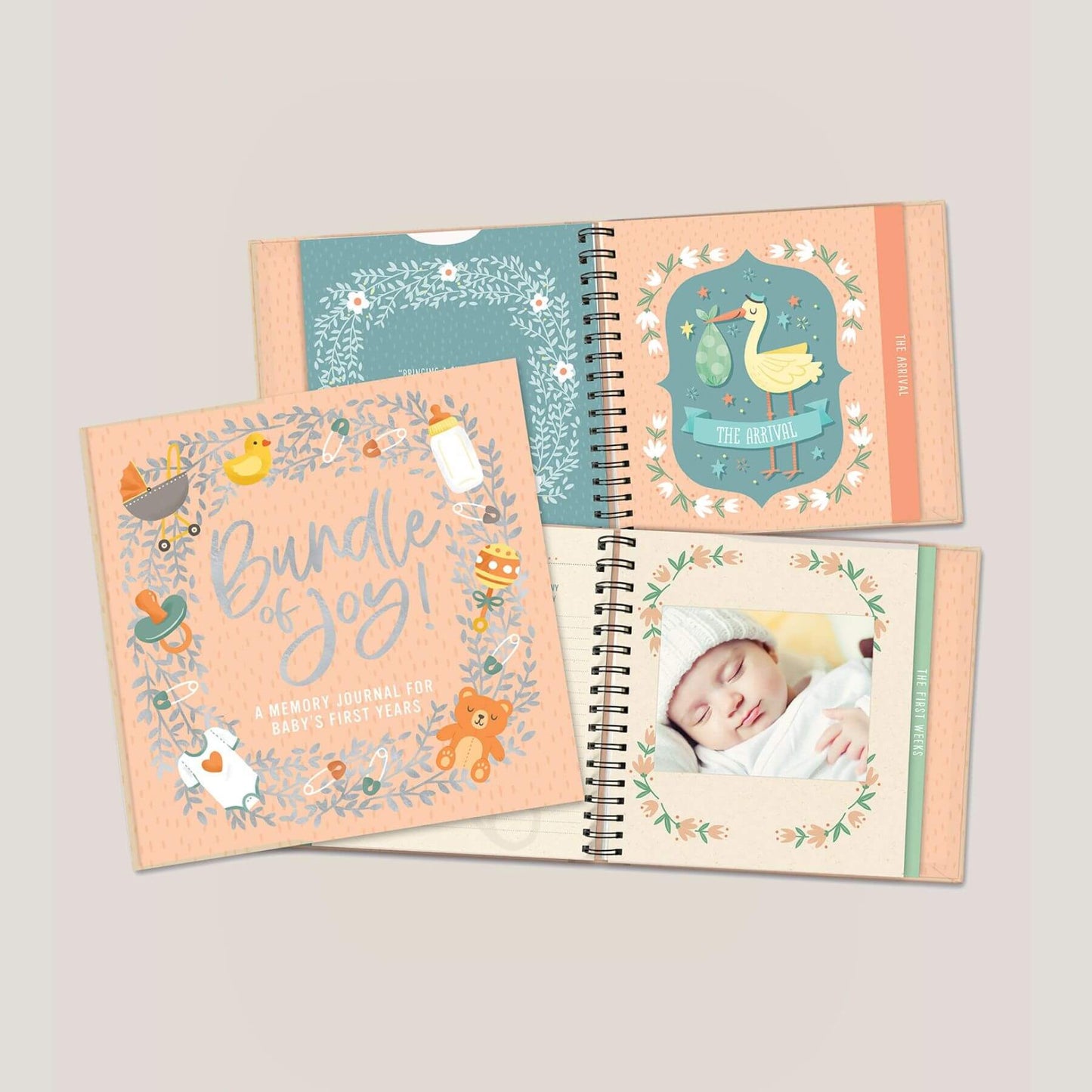 Baby memory journal with illustrations and a photo of a baby on a light gray background