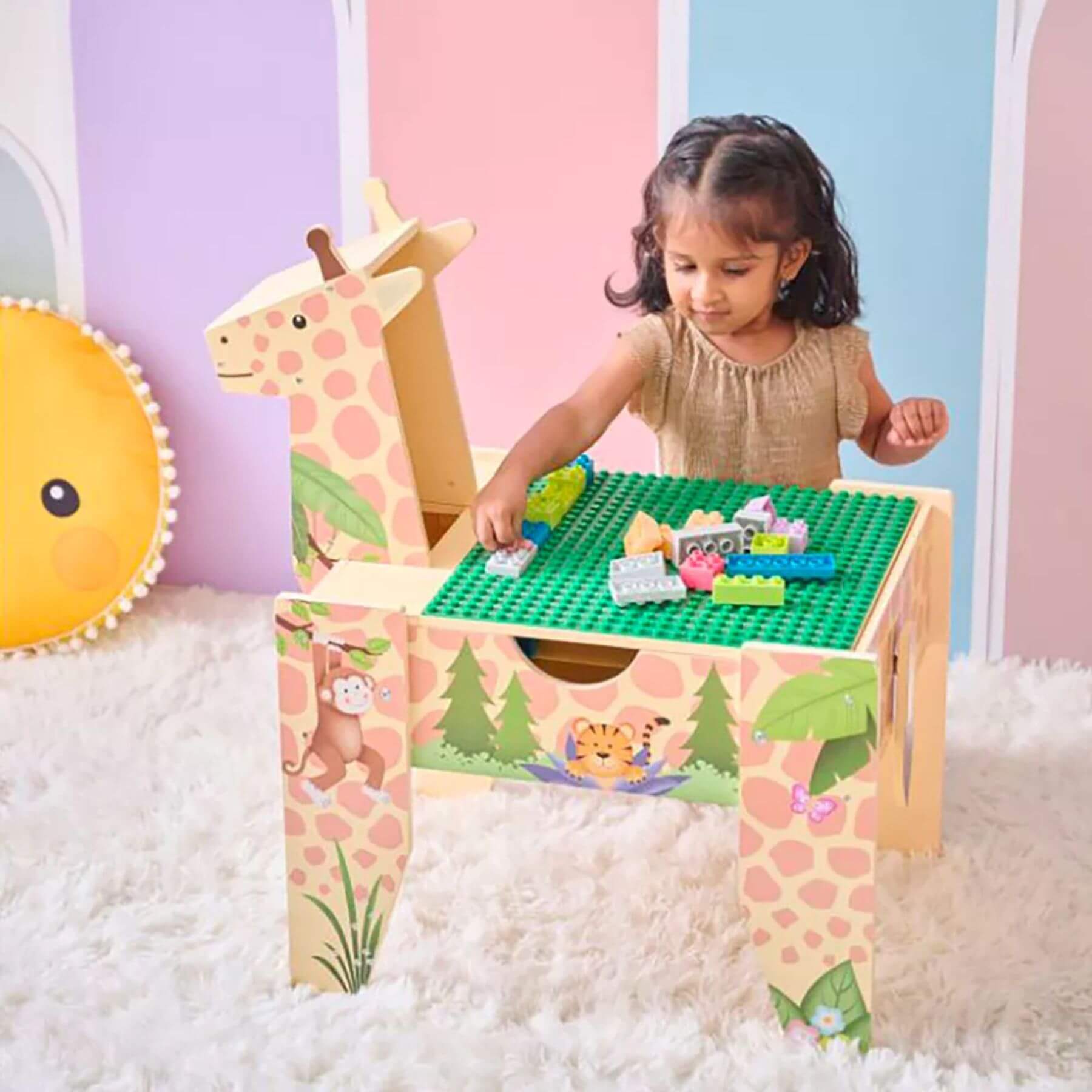 Child playing with Teamson Kids Jungle Giraffe 2-in-1 Wooden Activity Table featuring animal prints and LEGO-like surface.