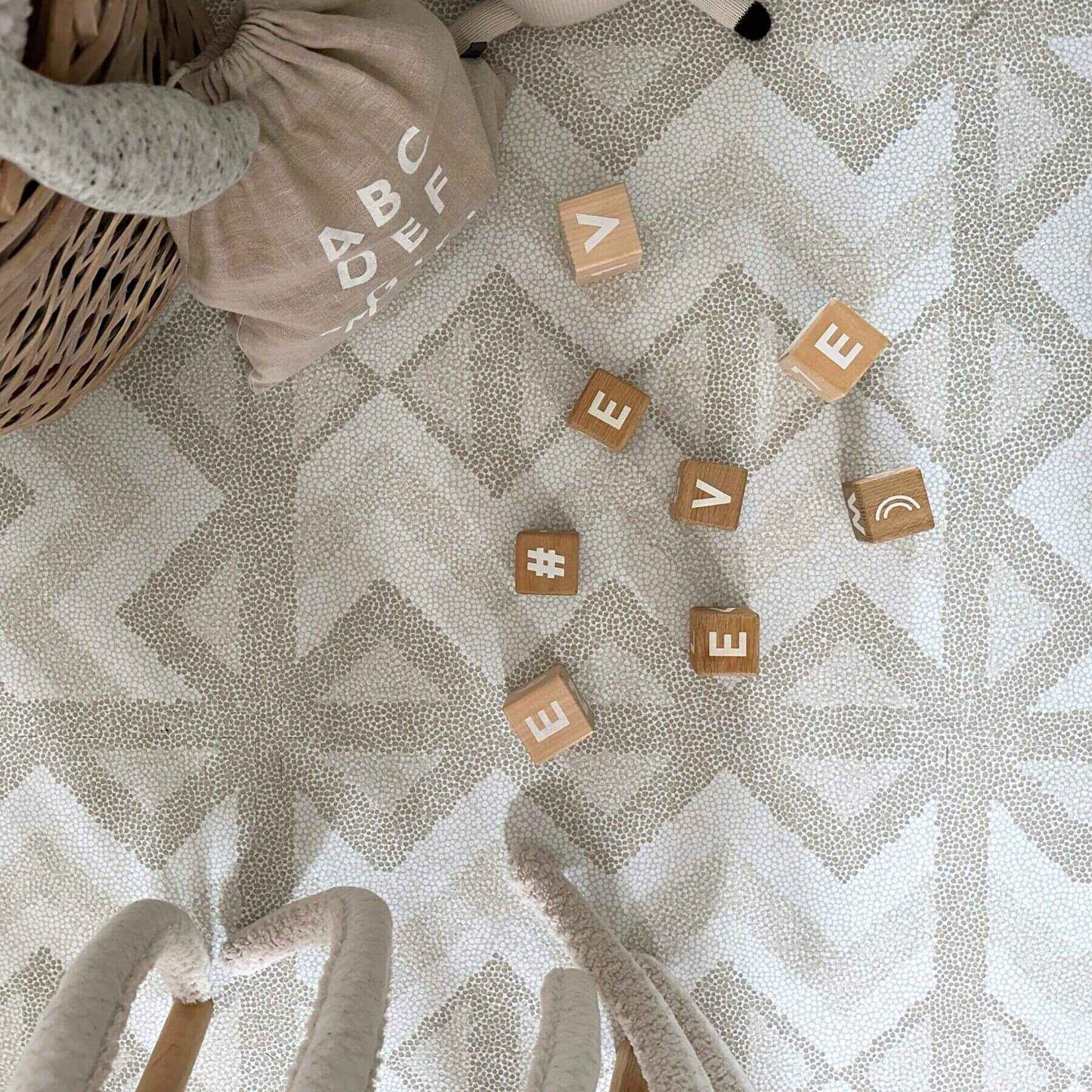 Wooden blocks with letters on Eeveve Kilim Play Mat, Feather Gray