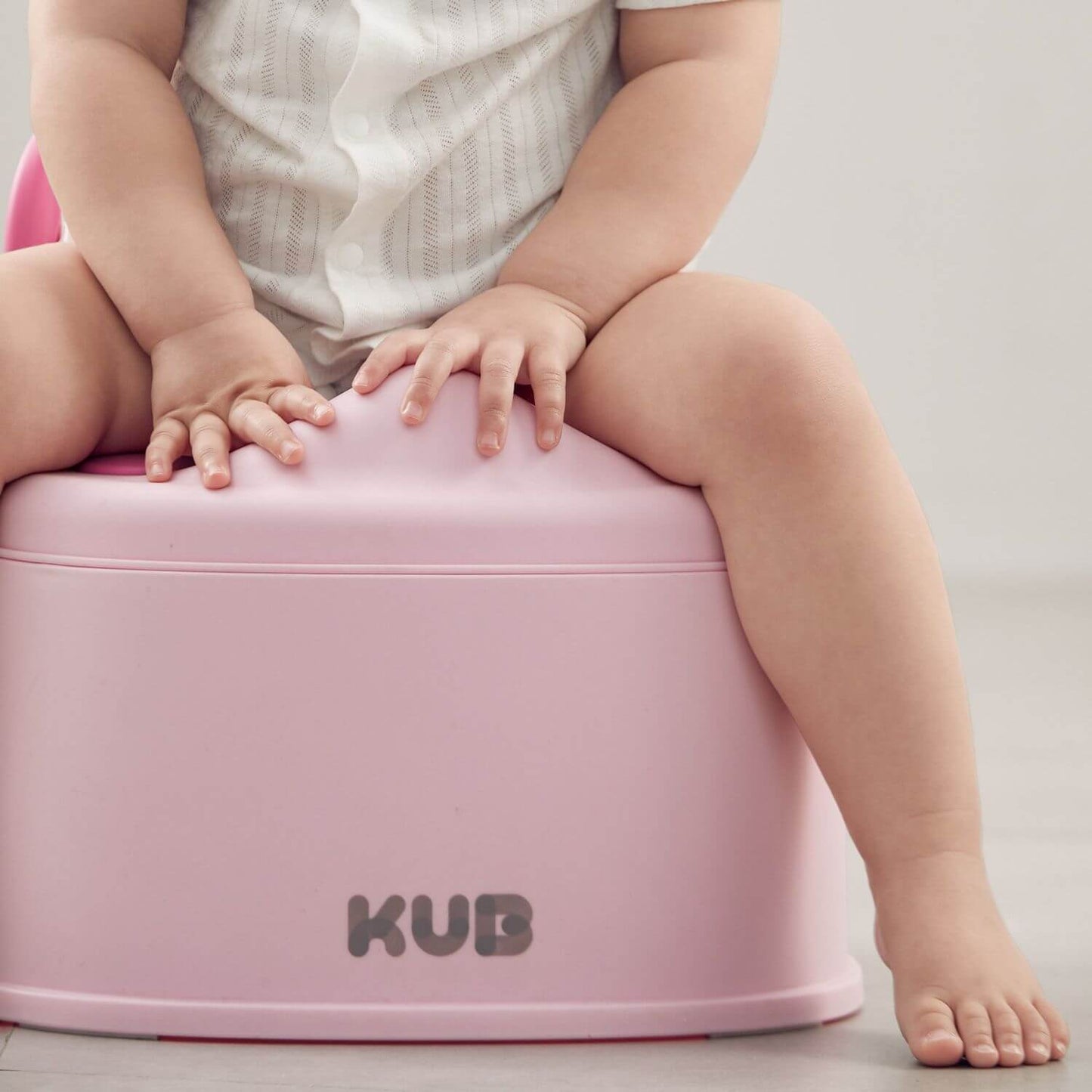 Baby Sitting on KUB Potty Training Toilet Pink