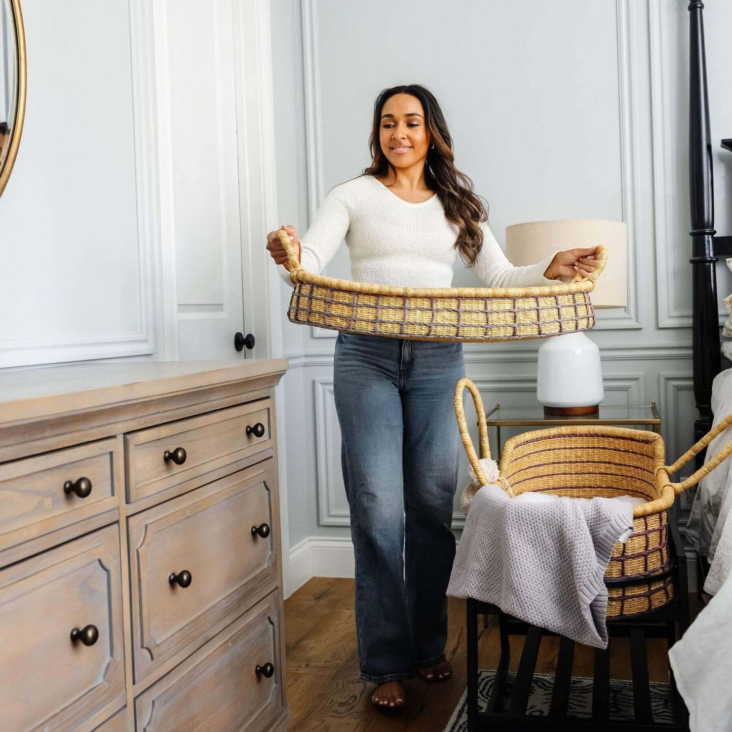 Woman holding Lavender Grid African Moses Basket Vegan Handle in a bedroom setting