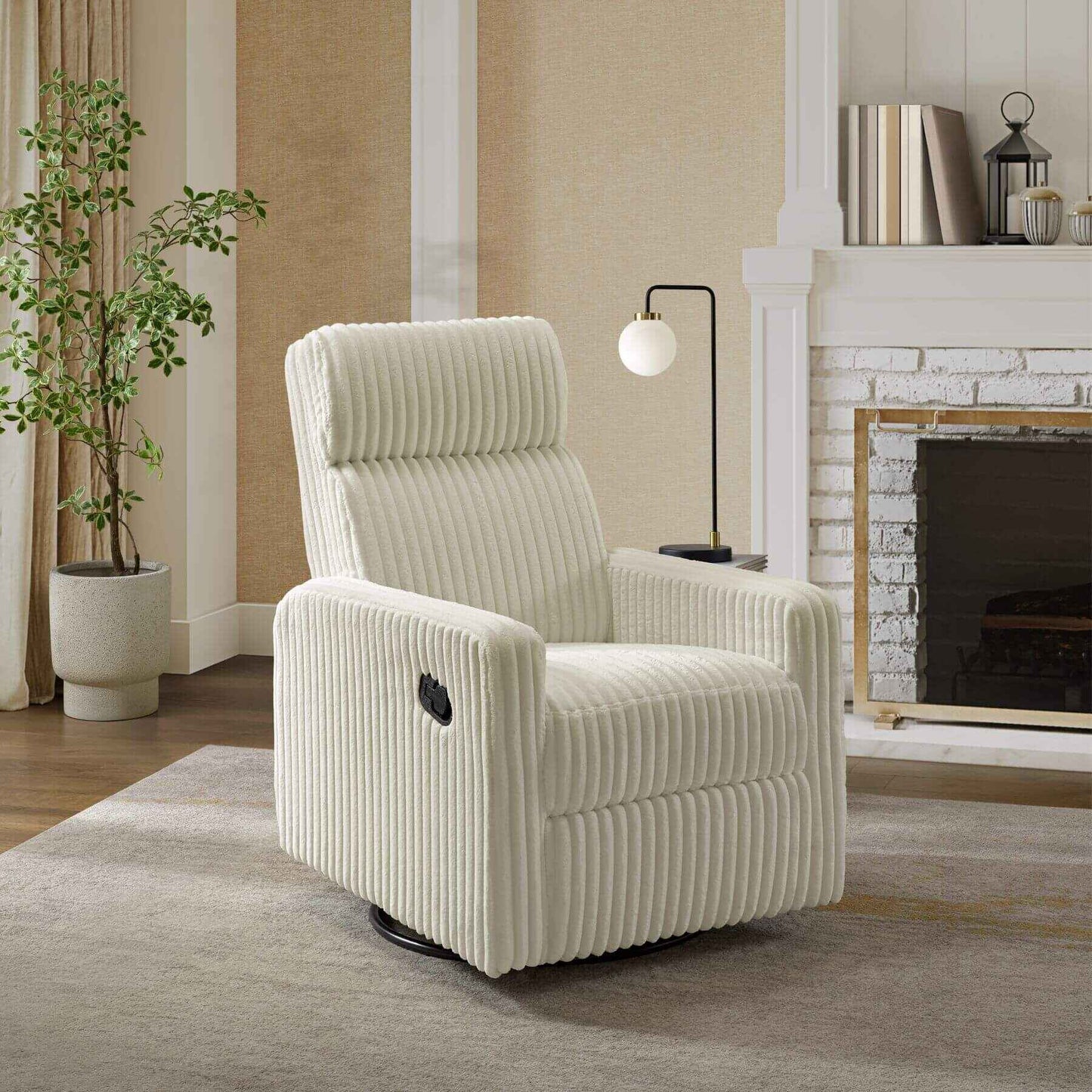 Oxford Baby Layton Glider / Recliner Pearl White in a living room setting with a fireplace and plant.