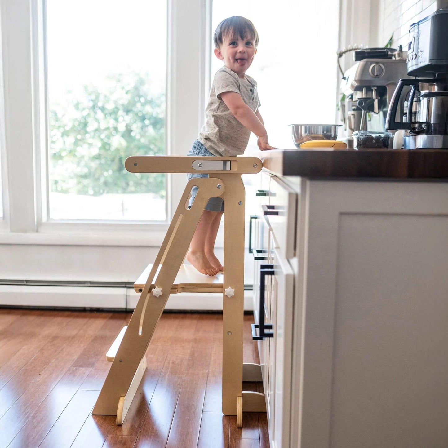 Boy Standing on Little Partners Learn 'N Fold Learning Tower Natural