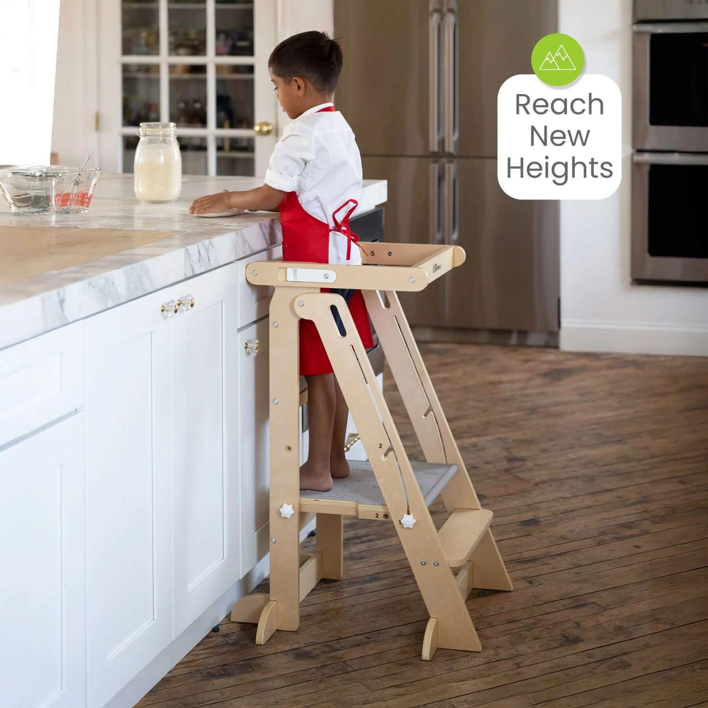 Boy Standing on Little Partners Learn 'N Fold Learning Tower Natural near Kitchen Tower