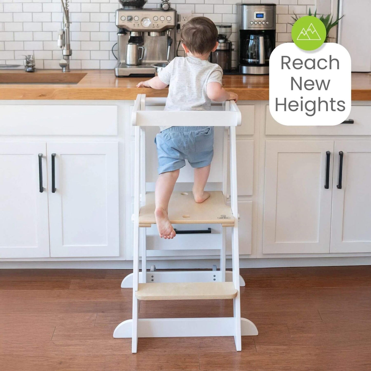Boy Standing on Little Partners Learn 'N Fold Learning Tower Natural & White
