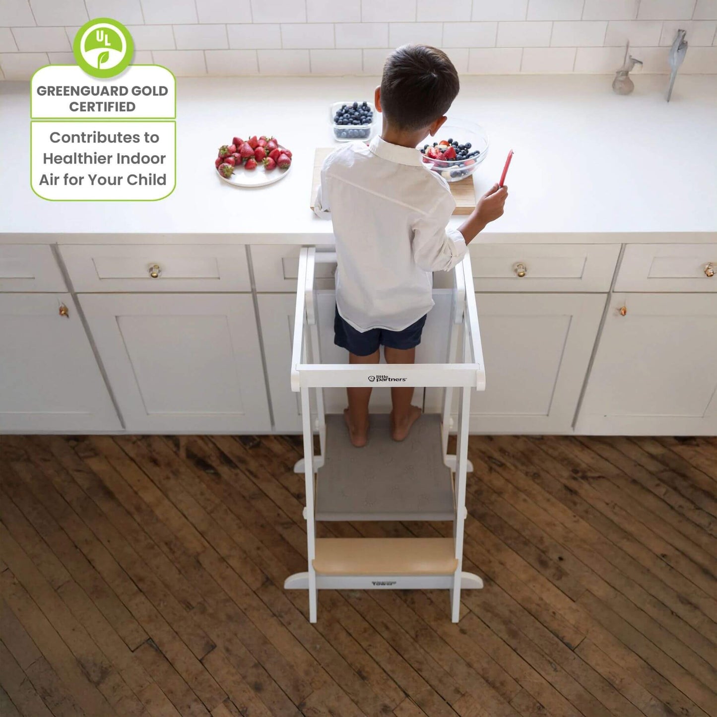 Boy Standing on Little Partners Learn 'N Fold Learning Tower Natural & White, Cutting Fruits