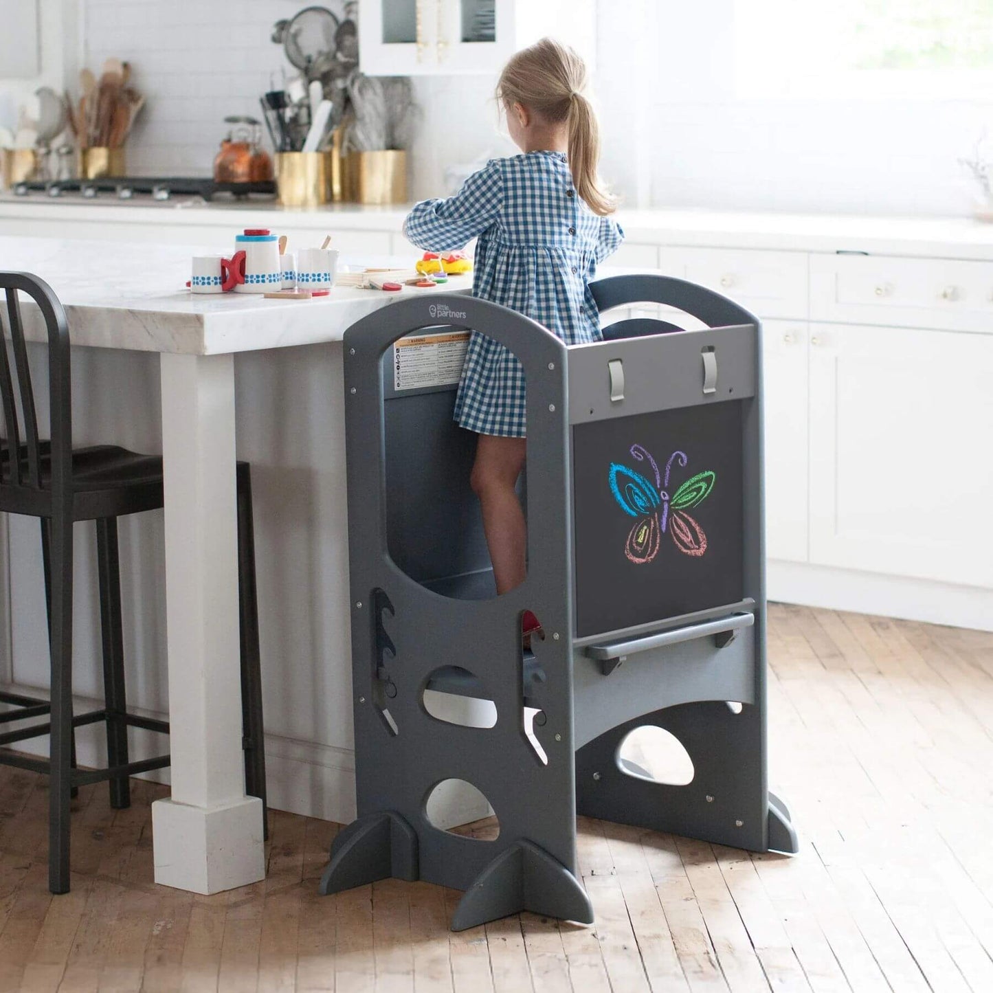 Girl Standing on Little Partners Limited Edition Learning Tower Grey, Playing