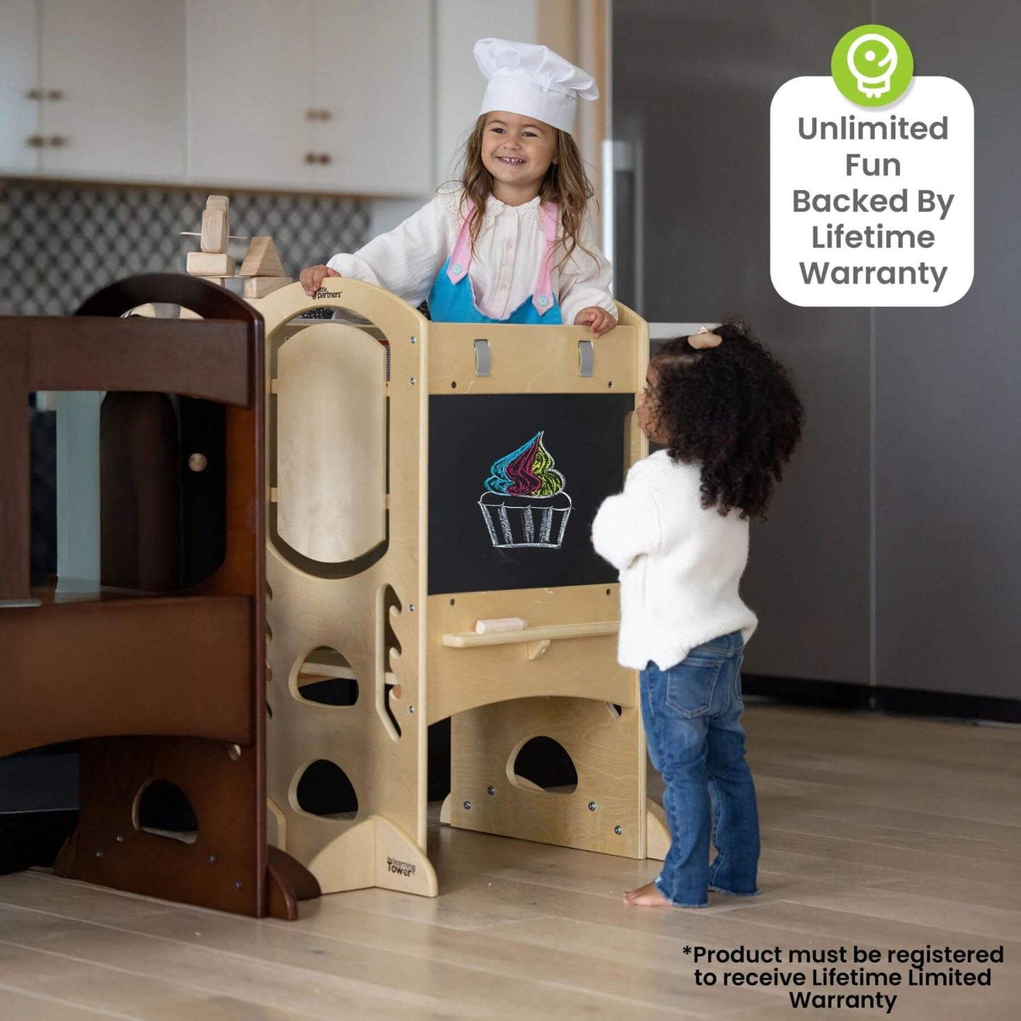 Girl Standing on Little Partners Limited Edition Learning Tower Natural
