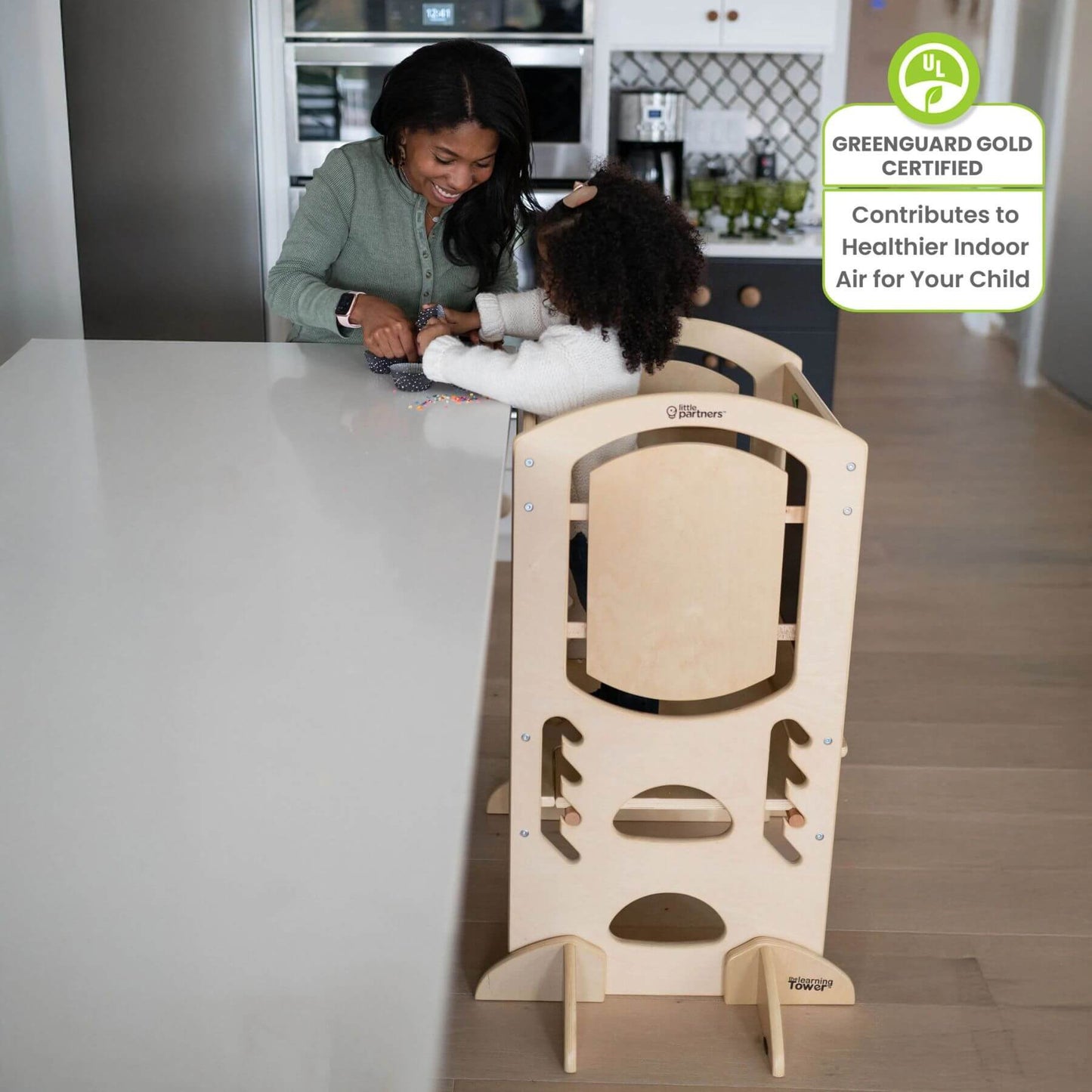 Girl Standing on Little Partners Limited Edition Learning Tower Natural, Helping mom Cook