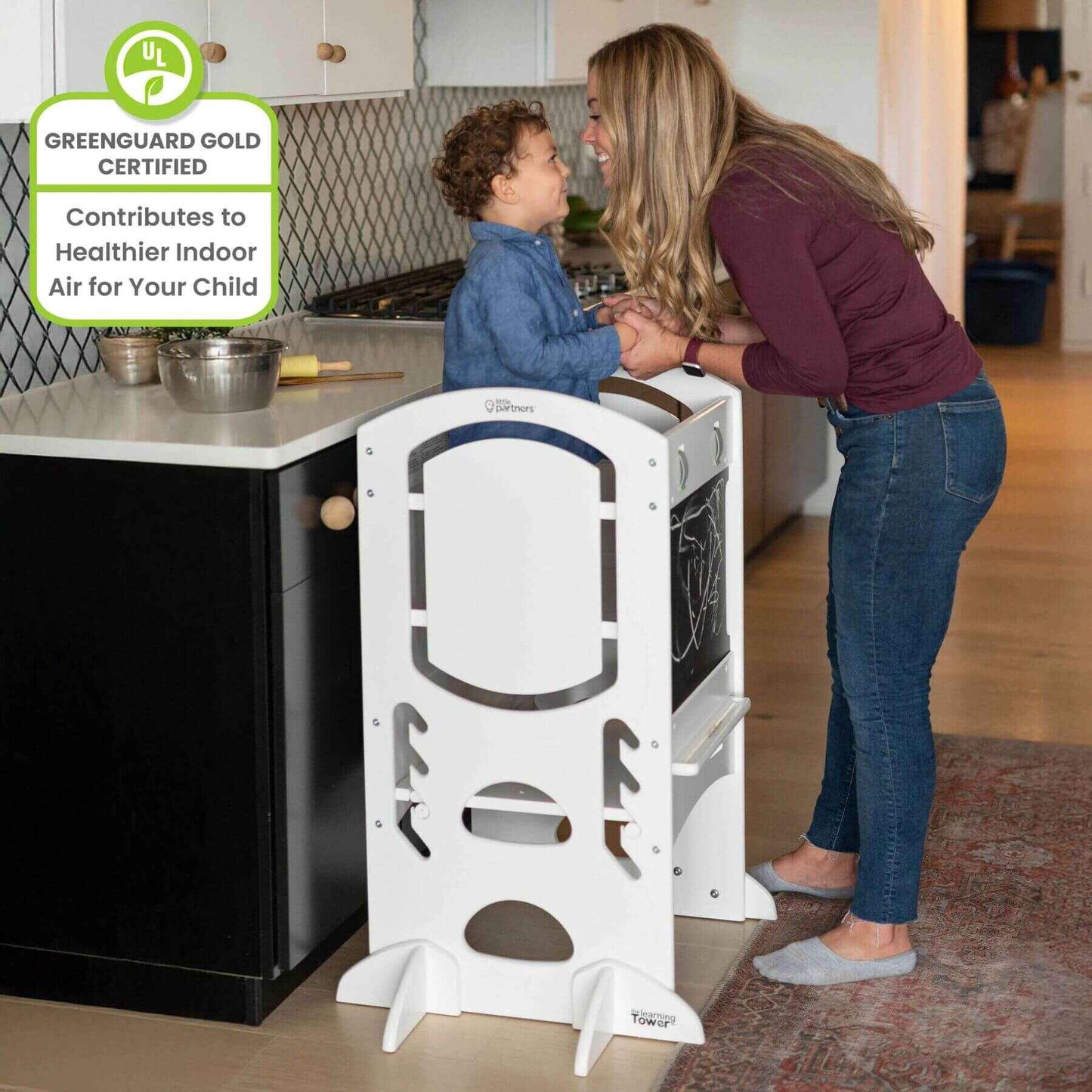 Mom Holding Hands of Boy, who is Standing on Little Partners Limited Edition Learning Tower White