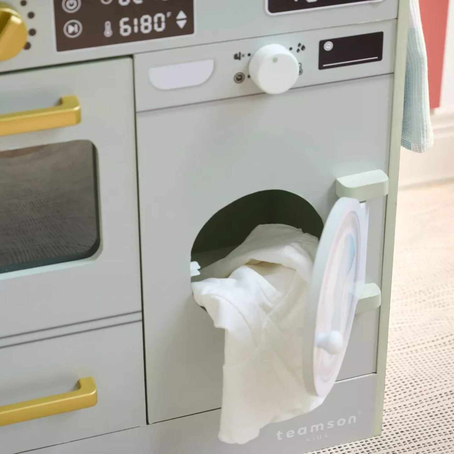 Children's toy dryer with clothes inside, brand 'teamson' visible