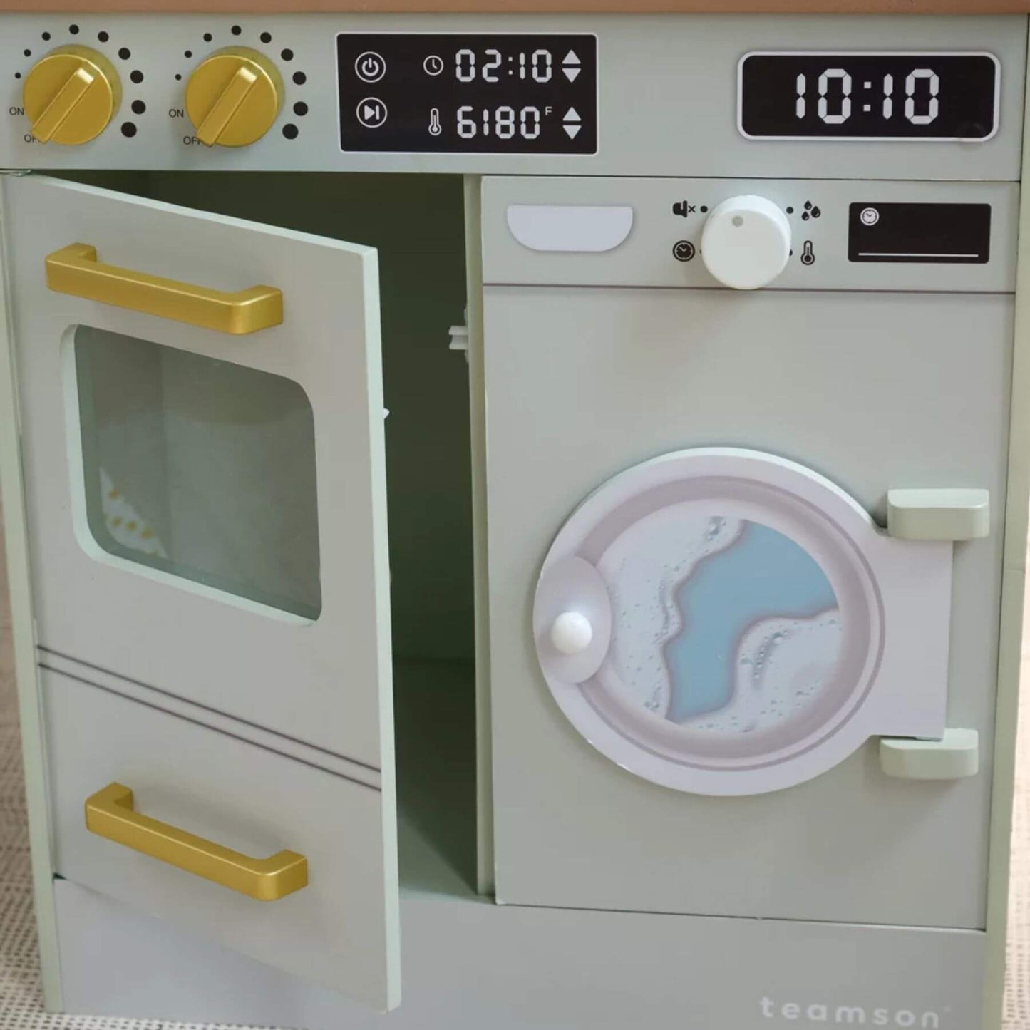Toy kitchen set with oven and washing machine, featuring digital displays and knobs.