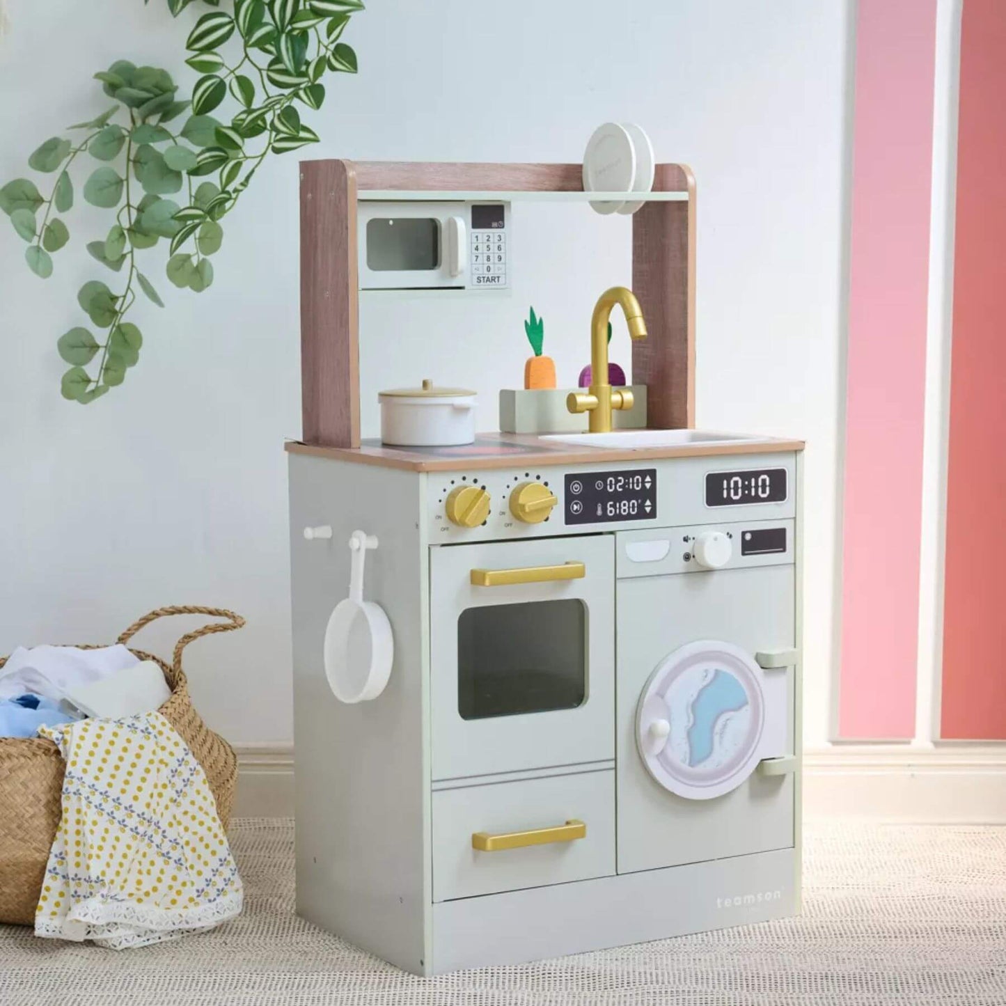 Teamson Kids Little Chef Lake Tahoe Wooden Play Kitchen Green against a light blue wall.