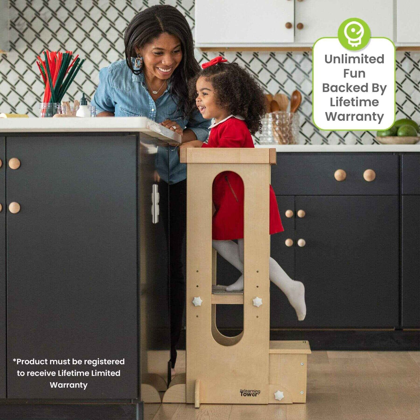 Girl Standing on Little Partners Explore 'N Store Learning Tower Natural next to Mom