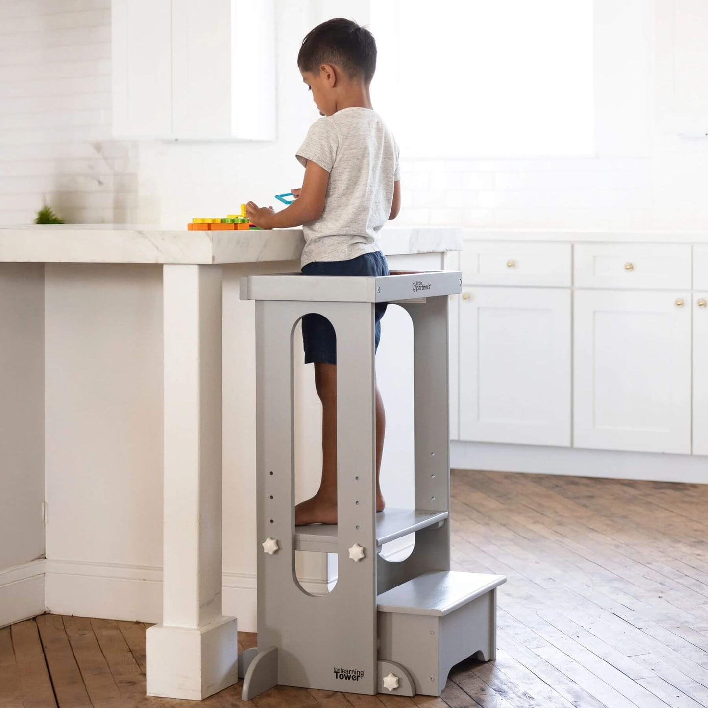 Boy Standing on Little Partners Explore 'N Store Learning Tower Silver