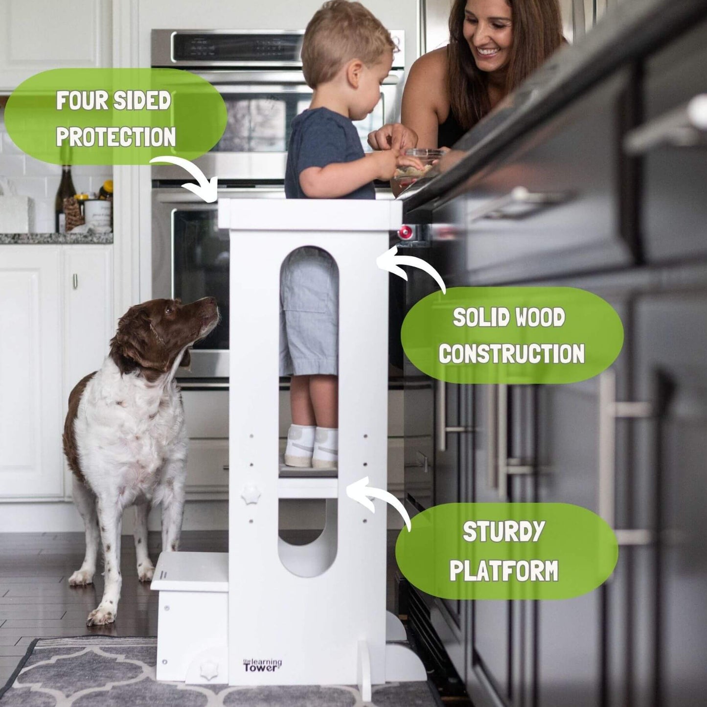 Boy standing on Little Partners Explore 'N Store Learning Tower White, helping mom