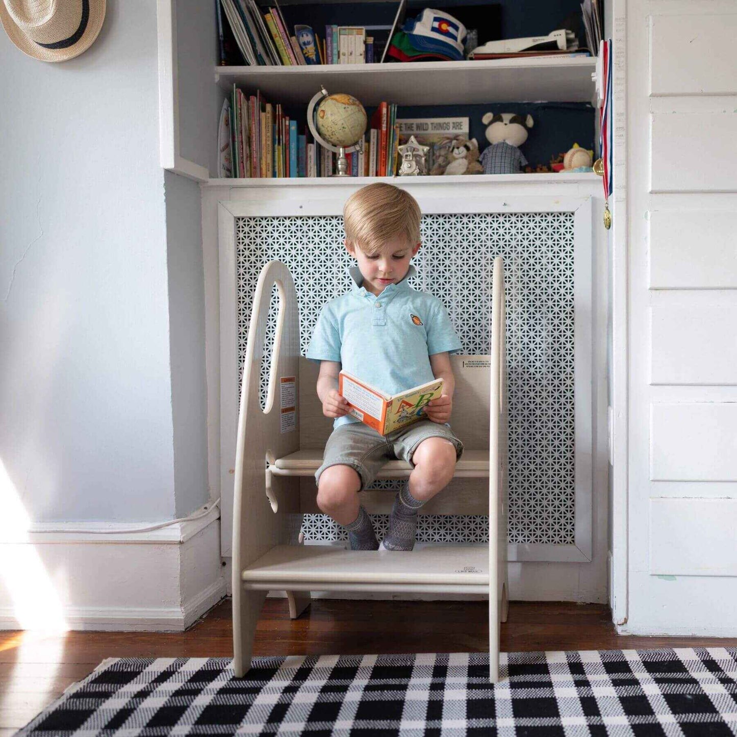 Boy Reading, Sitting on Little Partners 3-in-1 Growing Step Stool Ivory