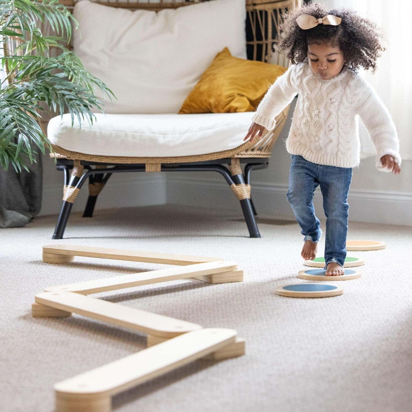 Child playing with Little Partners Learn 'N Balance Set in a home setting