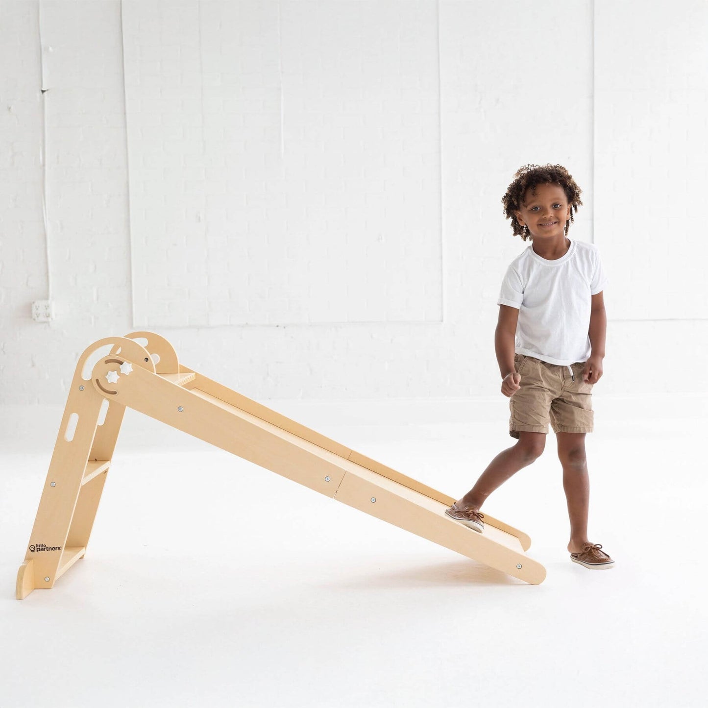 Boy Standing next to Little Partners 2-in-1 Learn 'N Slide/Climb